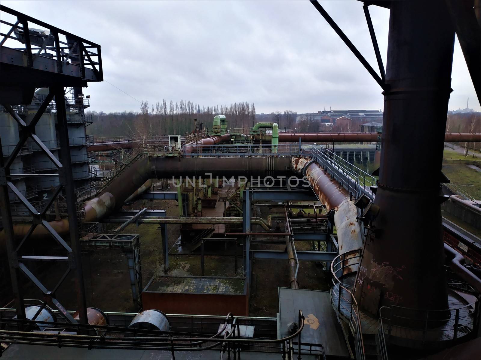 View on rusty tubes and pipes of old industrial plant in Duisburg by pisces2386