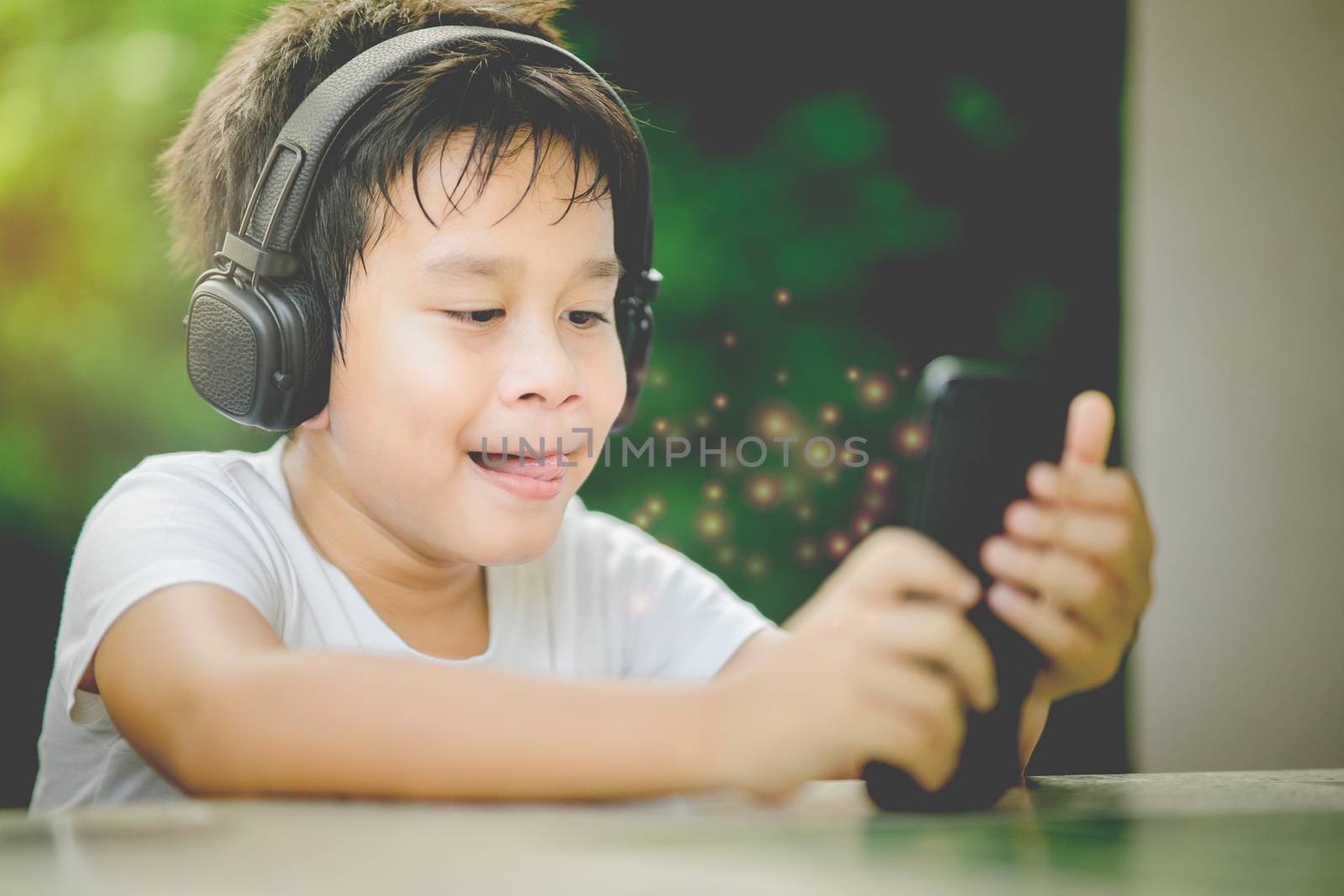 The boy listening to music from smartphone by rainyrf