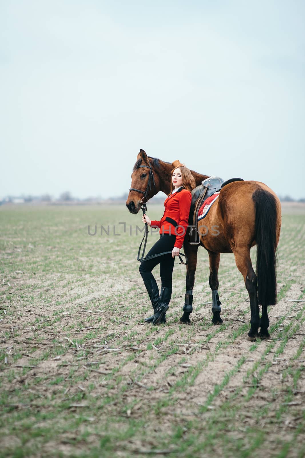 red-haired jockey girl in a red cardigan and black high boots wi by Andreua