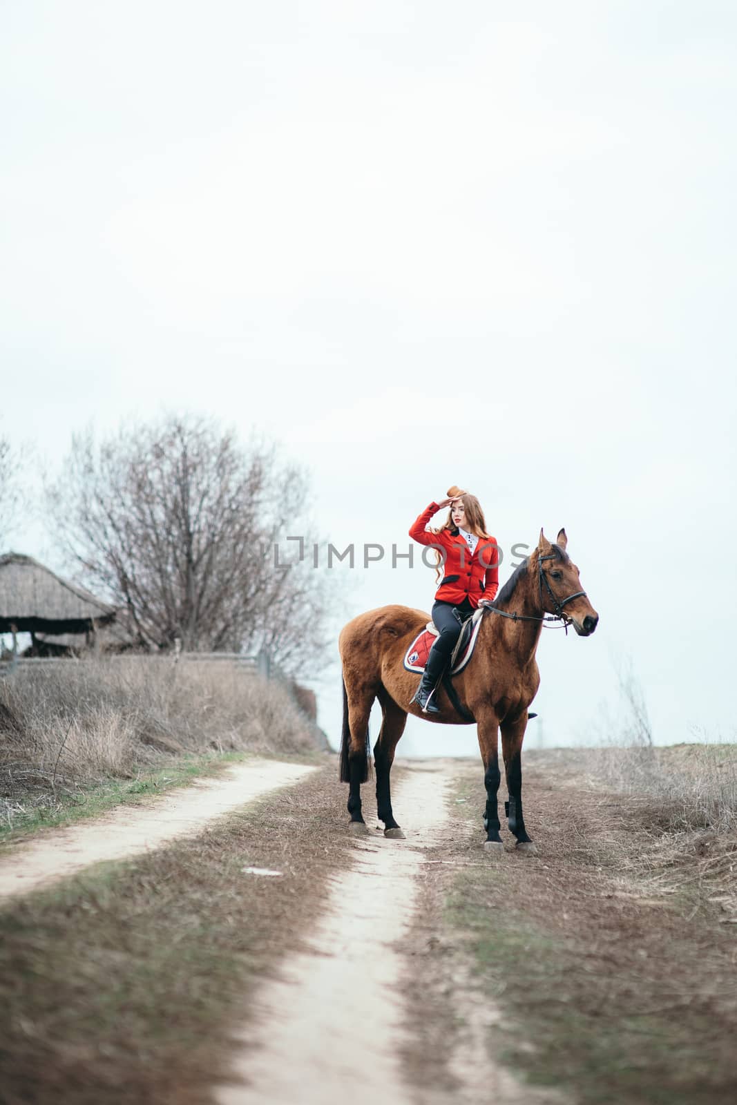 red-haired jockey girl in a red cardigan and black high boots wi by Andreua