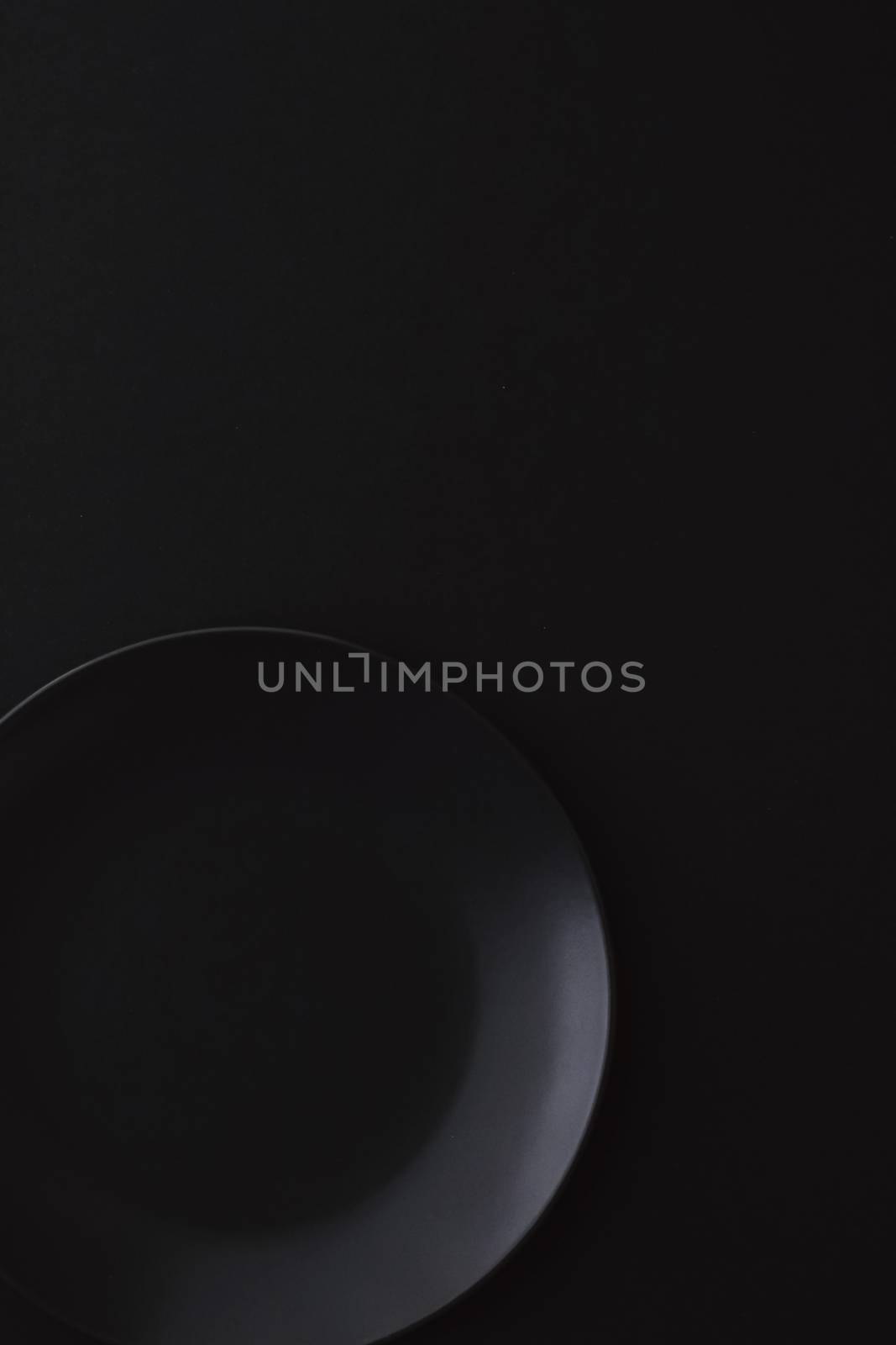 Empty plates on black background, premium dishware for holiday dinner, minimalistic design and diet concept