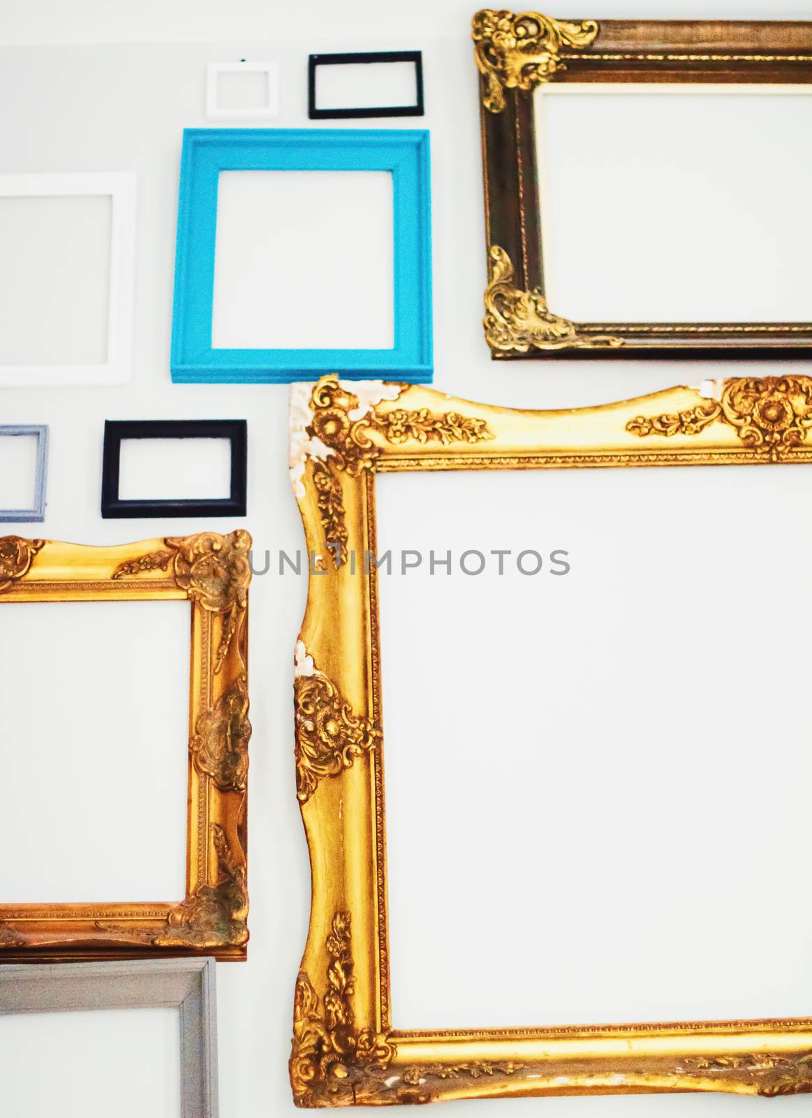 Empty art frames on gallery wall, decor and design details