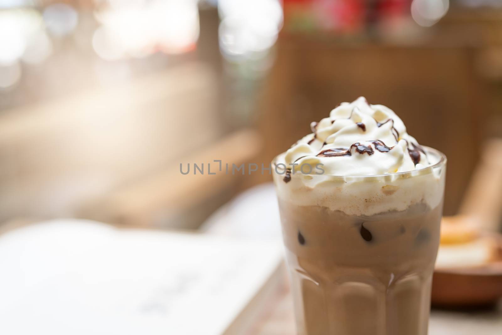 cup of iced mocha coffee on wooden table background. food and drink concept