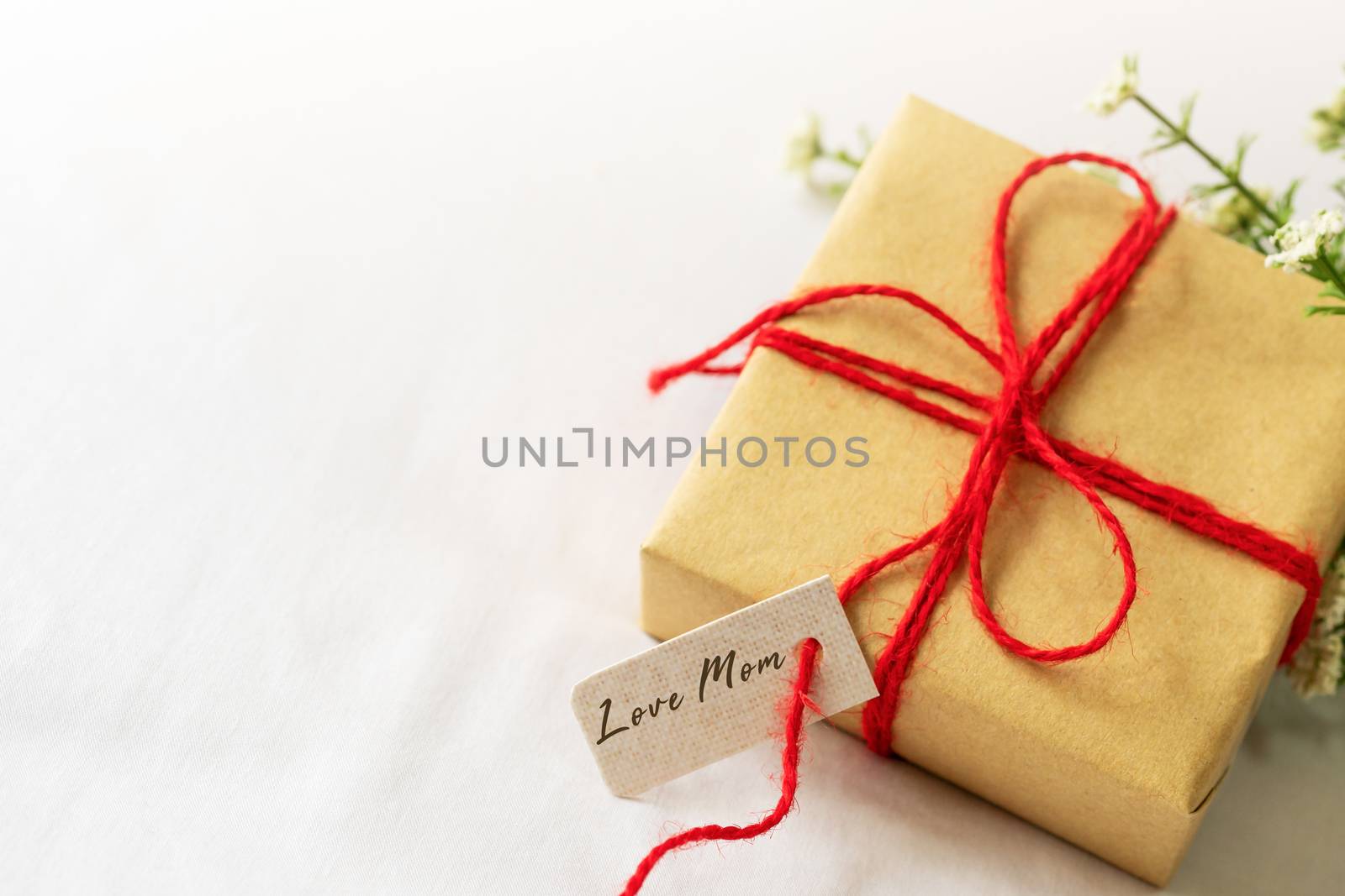 Happy mother's day concept. Gift box and flower, paper tag with  by psodaz