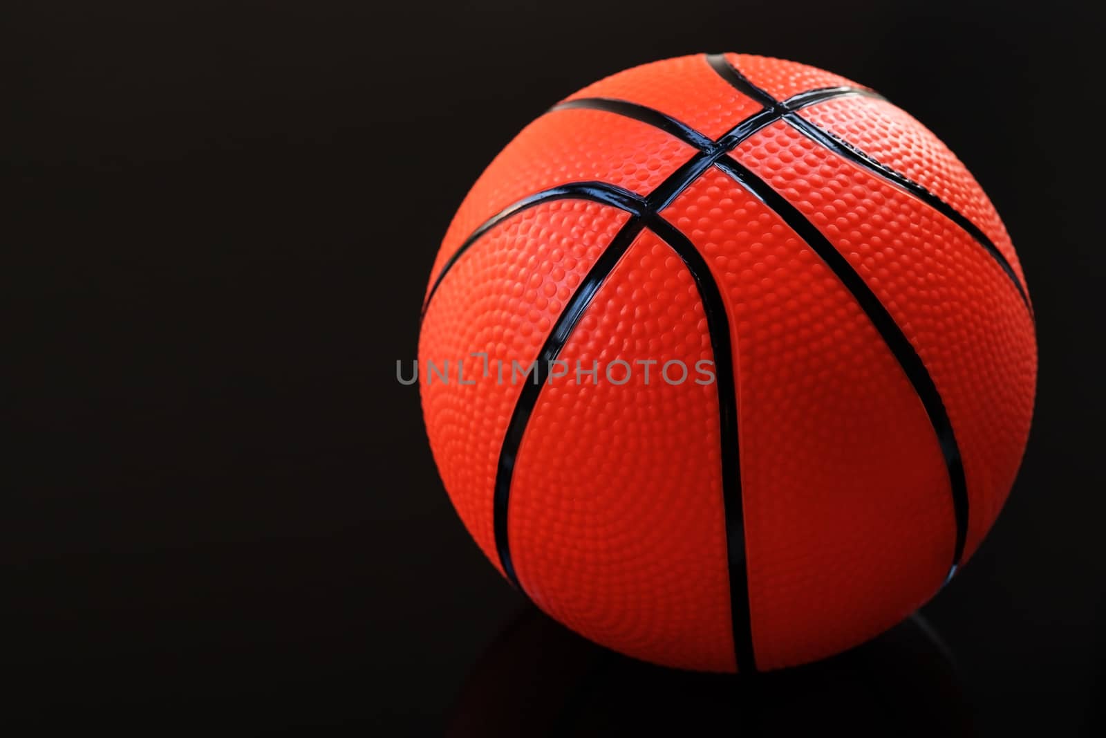 Basketball on a black background as a sports and fitness activity