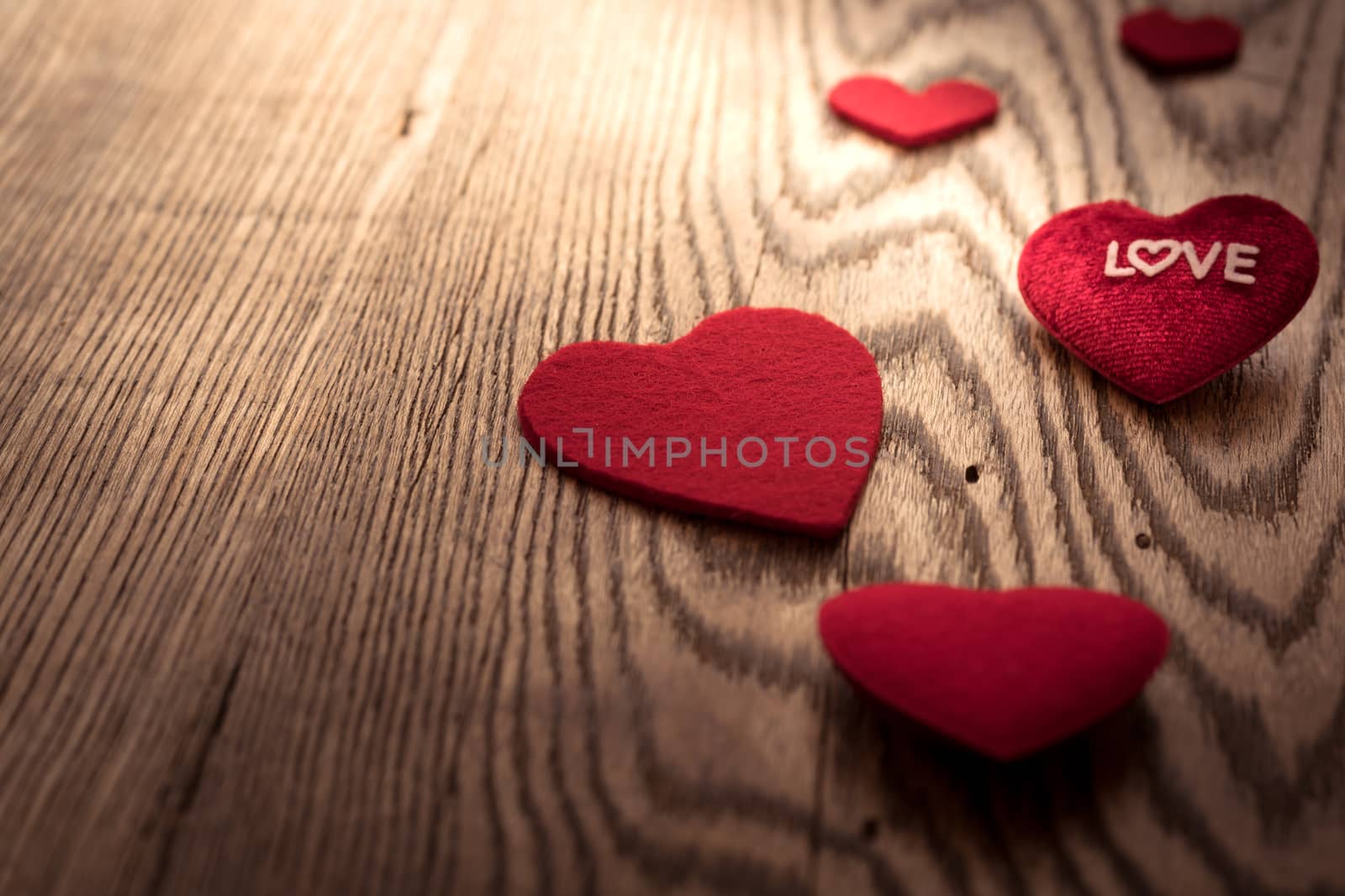 LOVE word on red heart on the wooden table backgrounds with copy space