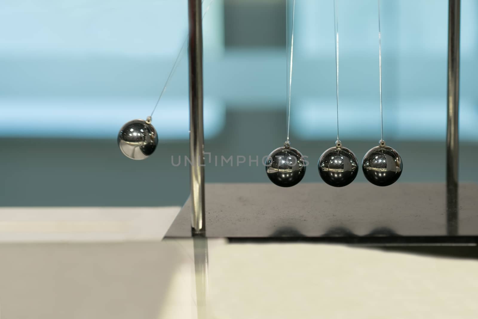 Balancing Balls Newton's Cradle on blurred backgrounds