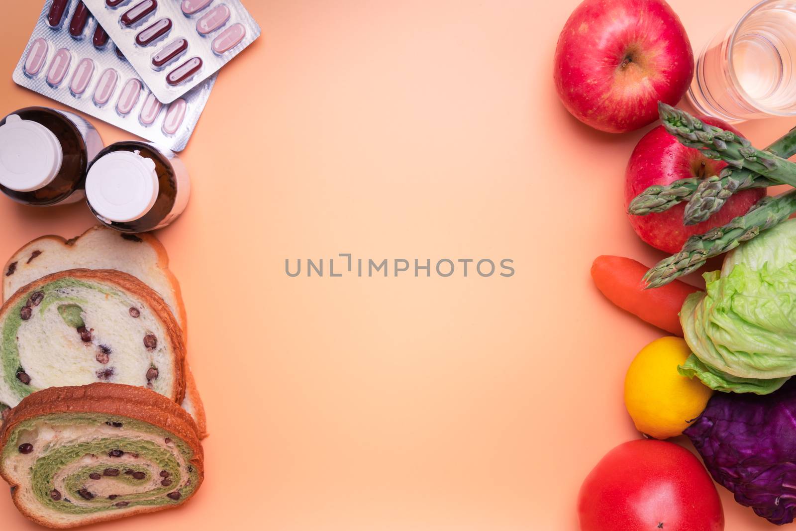 healthy food fruit and vegetable against junk food and supplementary medicine on orange background