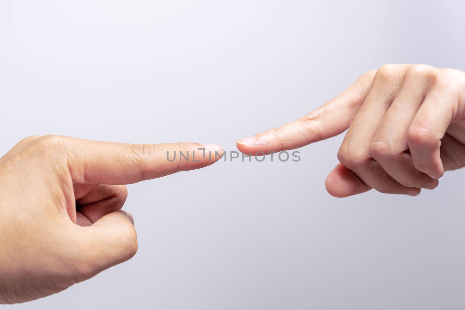 finger point touching men and women hands reaching towards each other, almost touching. Diversity differential concept