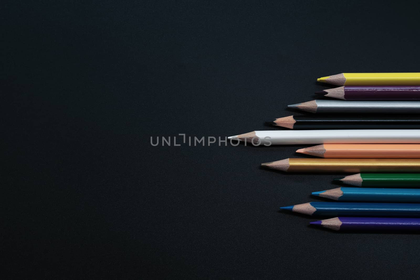 Teamwork concept. group of color pencil on black background