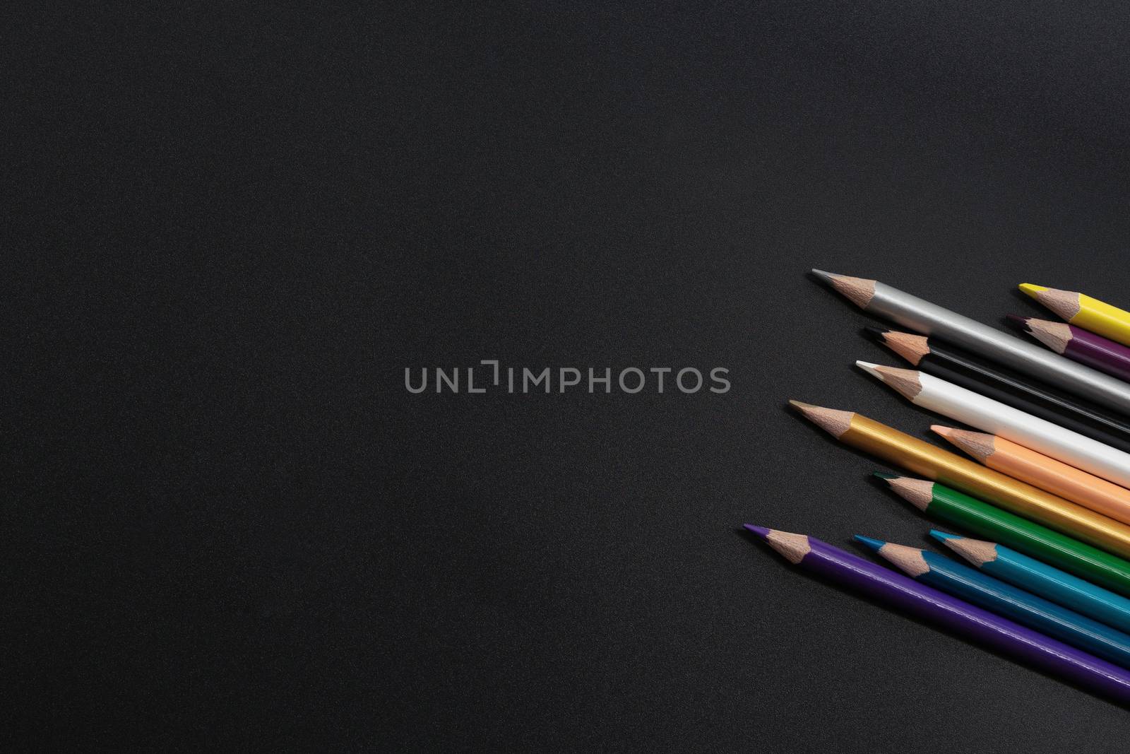 group of pencils on the black background with copy space by psodaz