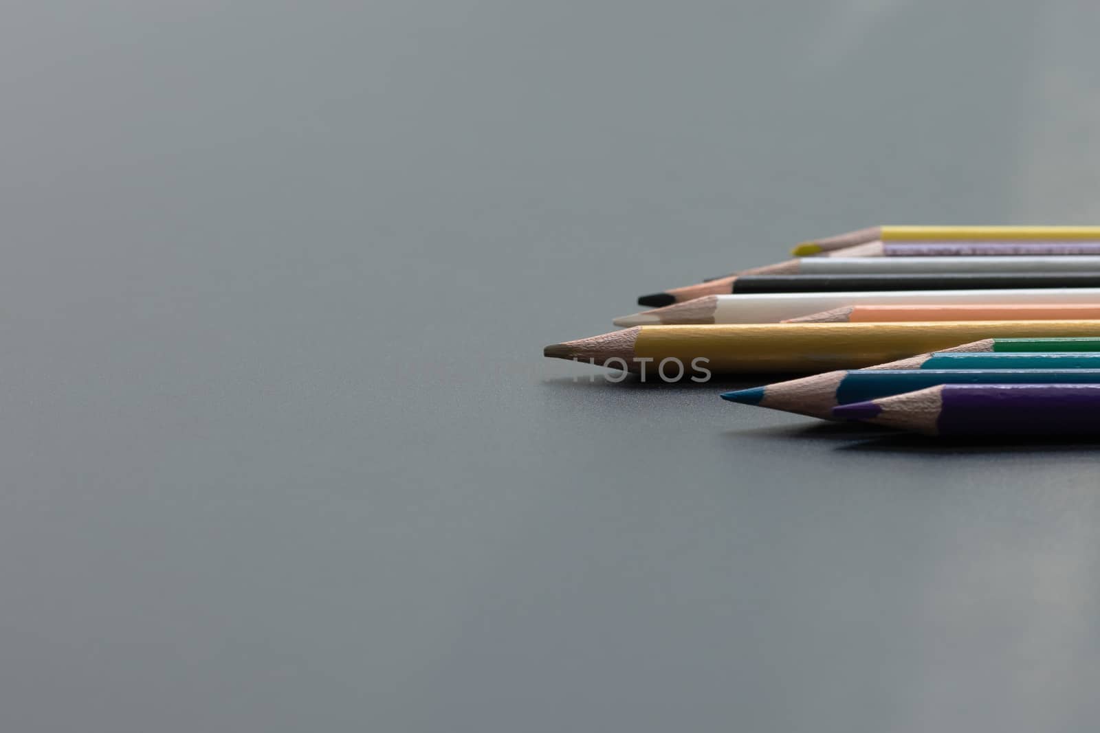 Leadership business concept. Gold color pencil lead other color on black background