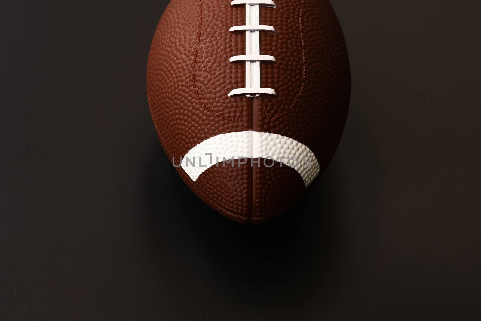 American football isolated on black background . Sport object concept