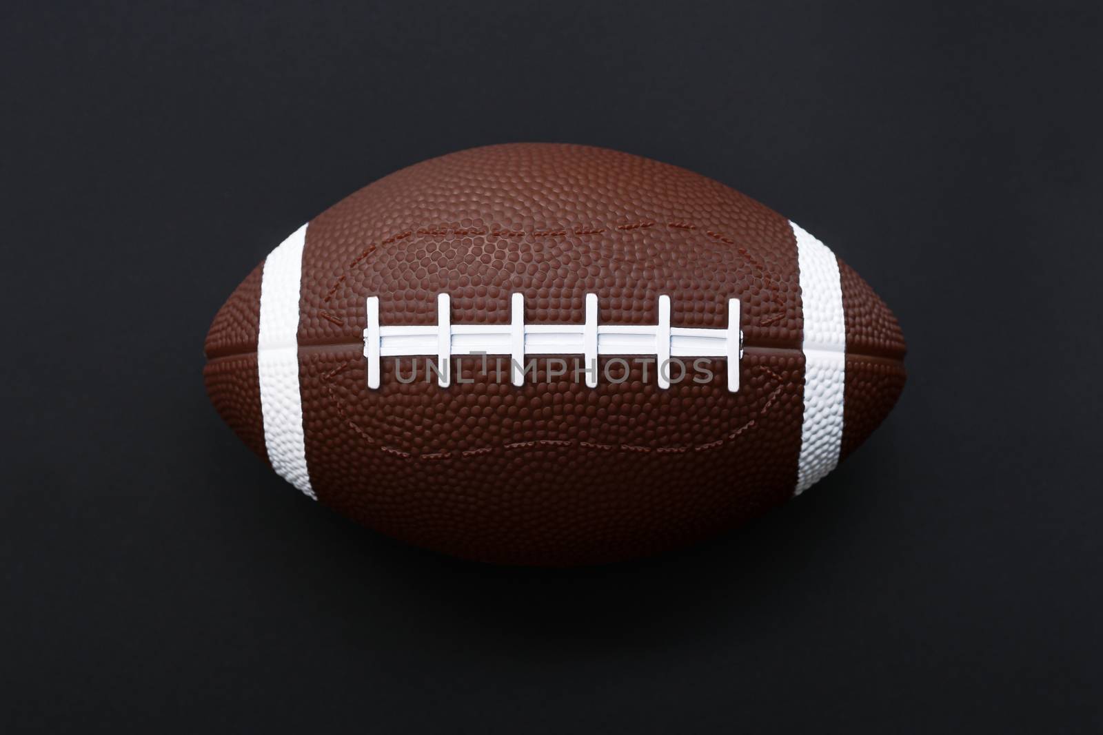 American football isolated on black background . Sport object concept