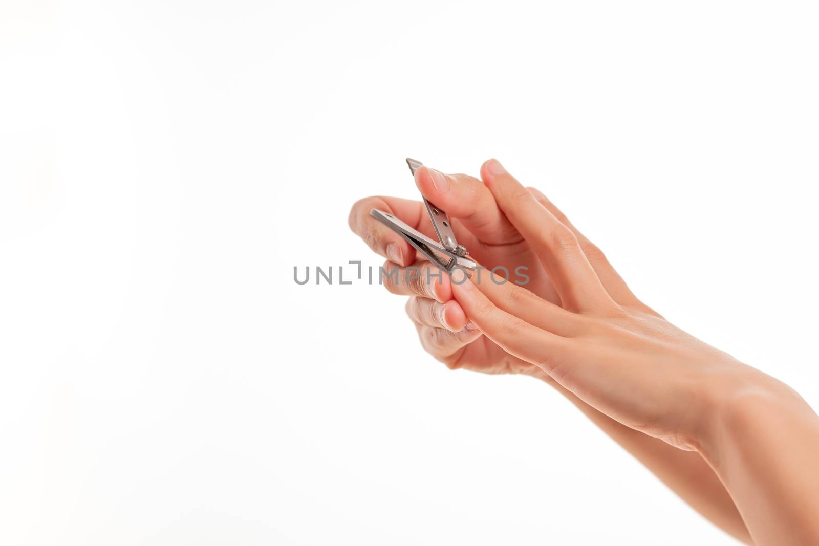 woman hand cutting nails using nail clipper on white backgrounds