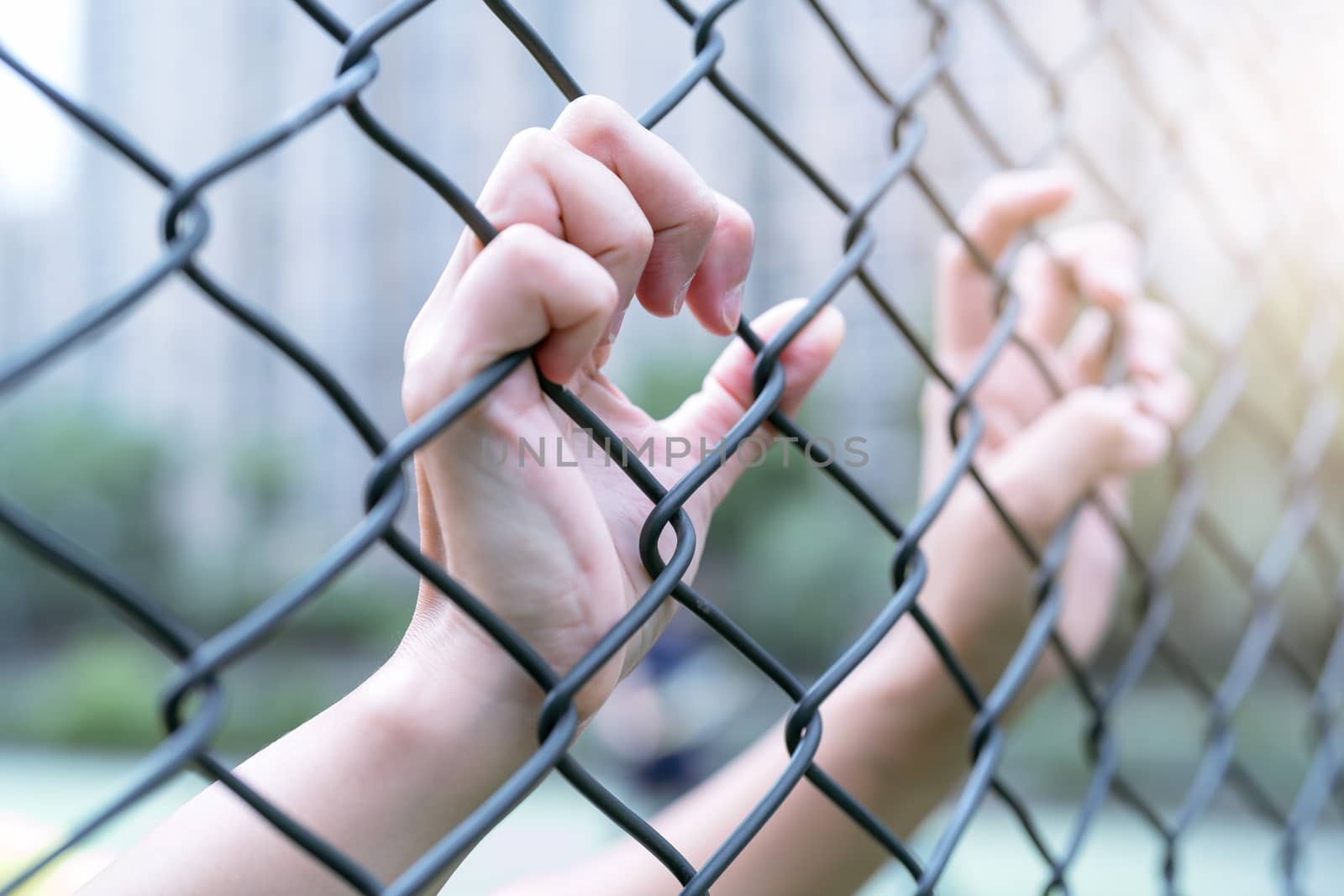 Depressed, trouble and solution. Women hand on chain-link fence. by psodaz