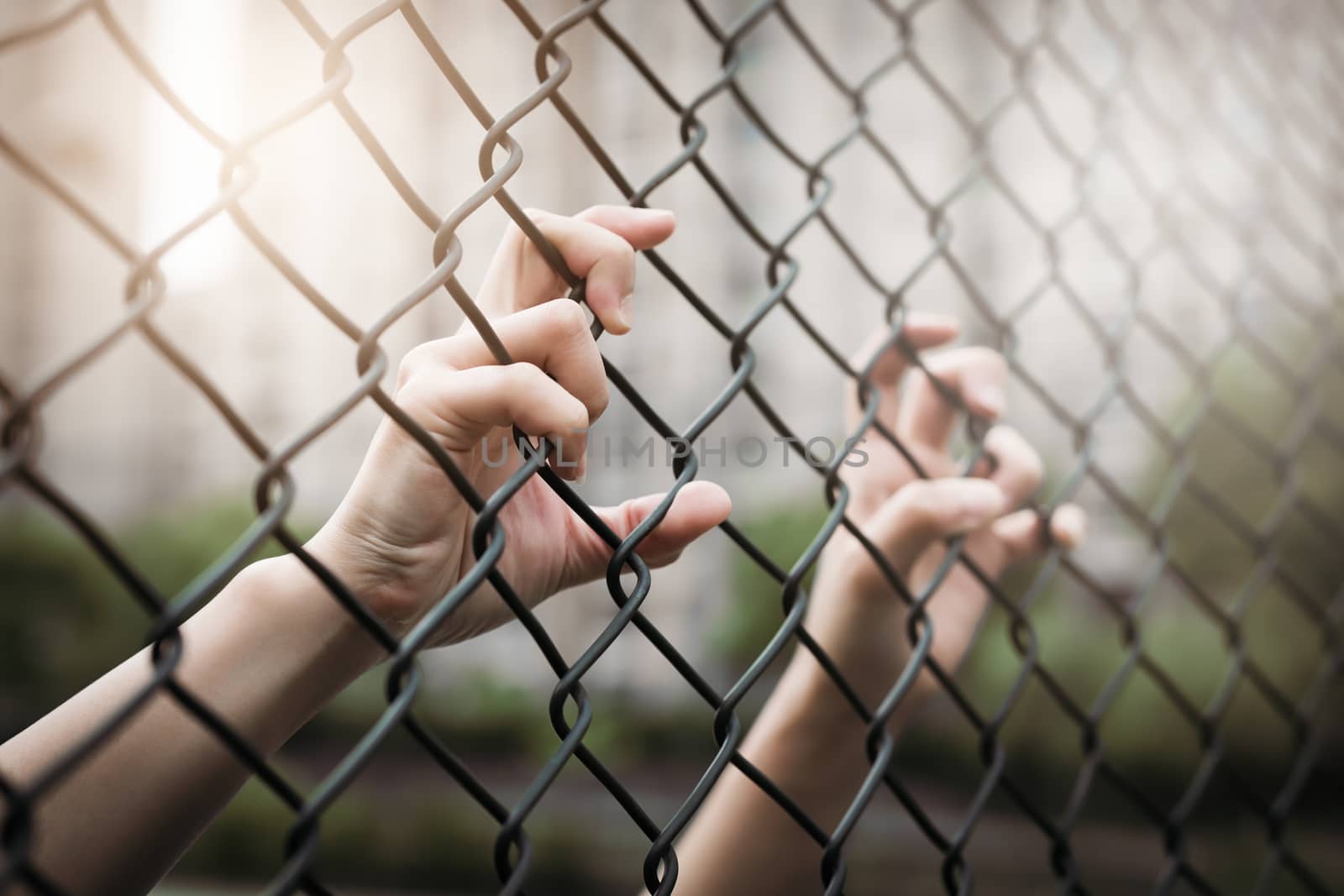 Depressed, trouble and solution. Women hand on chain-link fence. by psodaz