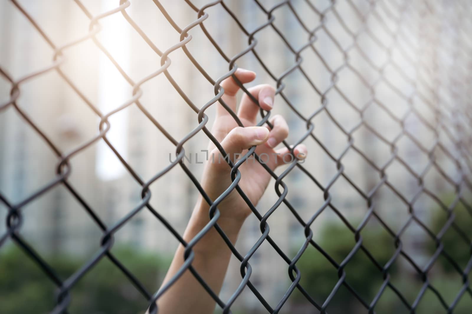 Depressed, trouble and solution. Women hand on chain-link fence. by psodaz