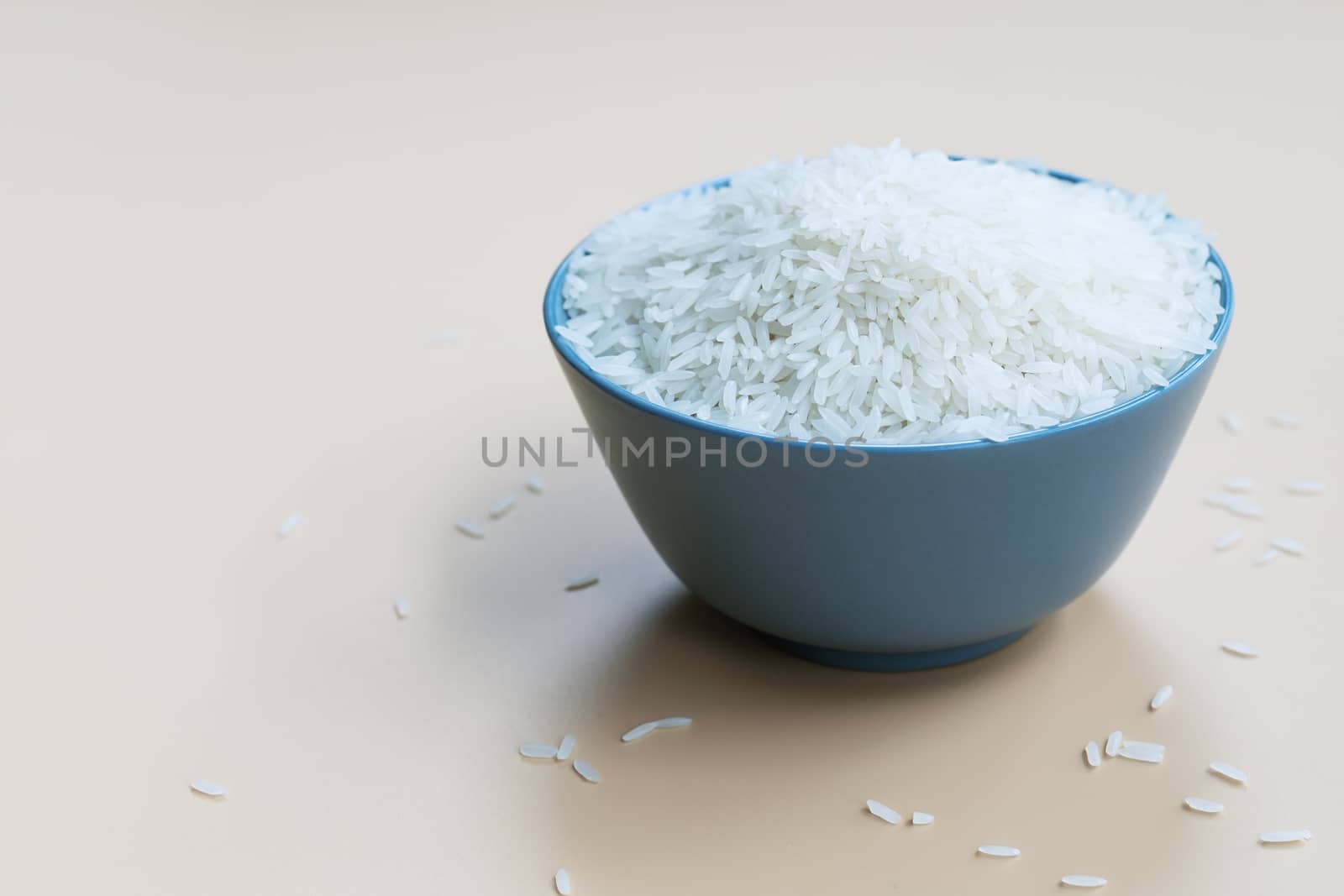 bowl of jasmine white rice on yellow backgrounds