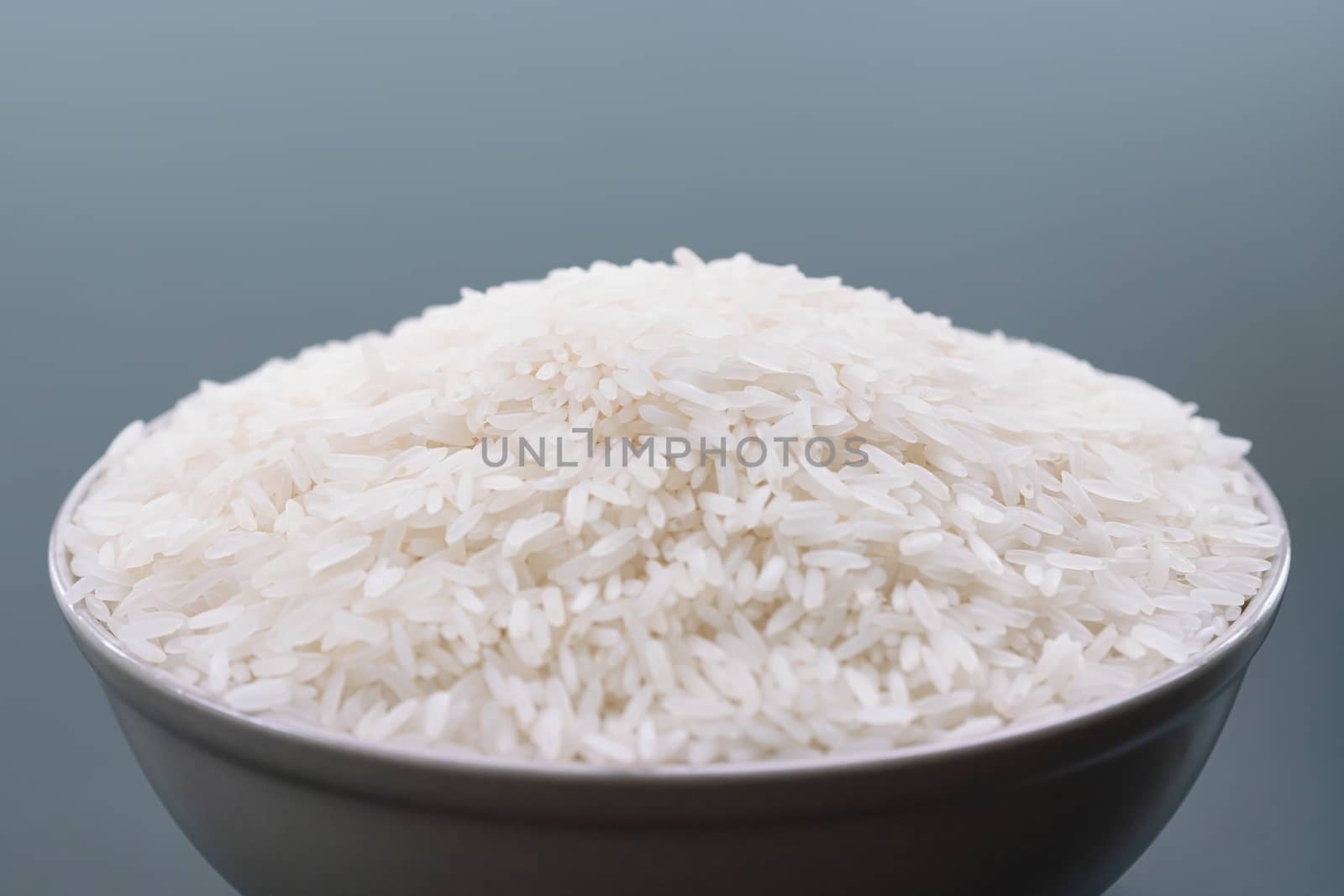 bowl of jasmine white rice on black backgrounds