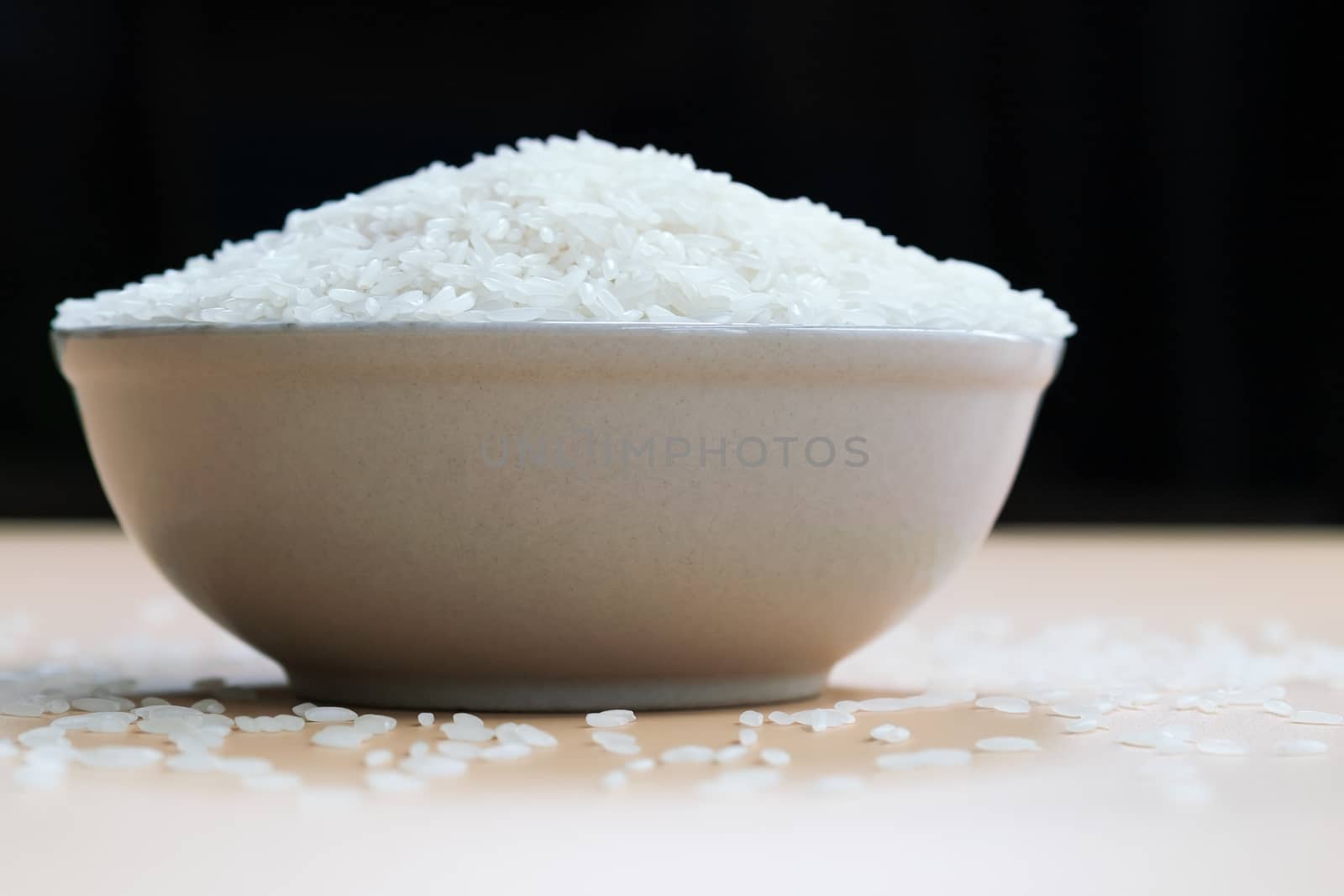 bowl of jasmine white rice on yellow backgrounds