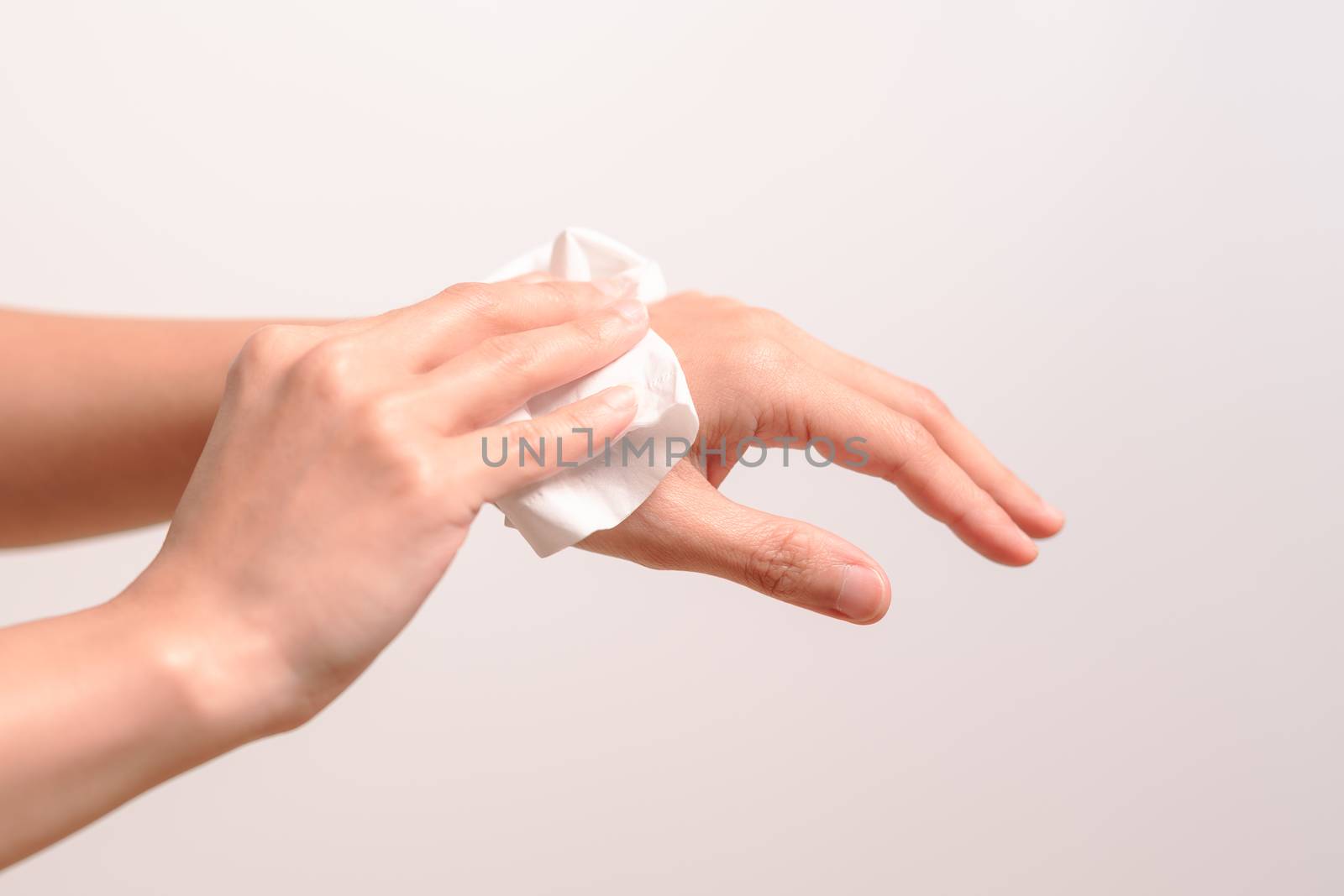 Woman cleaning her hands with white soft tissue paper. isolated on a white backgrounds