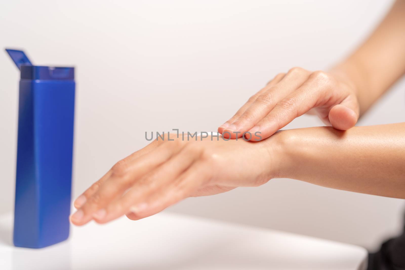 UV Protection Body Lotion Skin Care Apply. women hands holding U by psodaz
