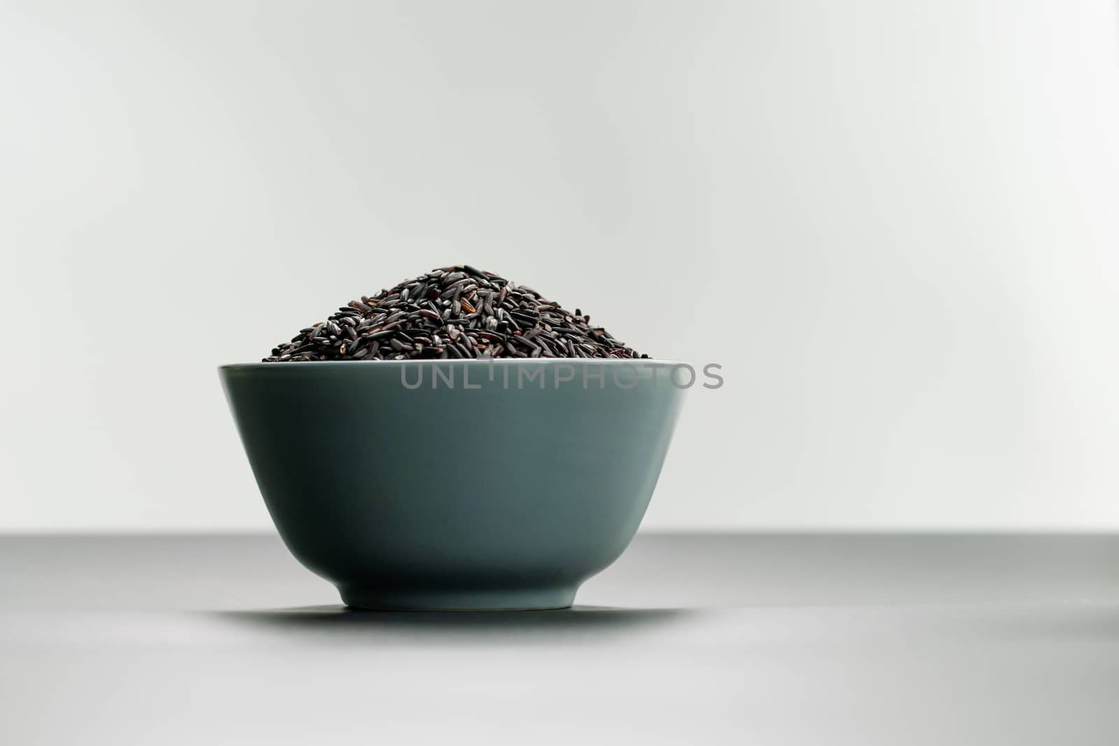 bowl of jasmine black rice on white backgrounds by psodaz