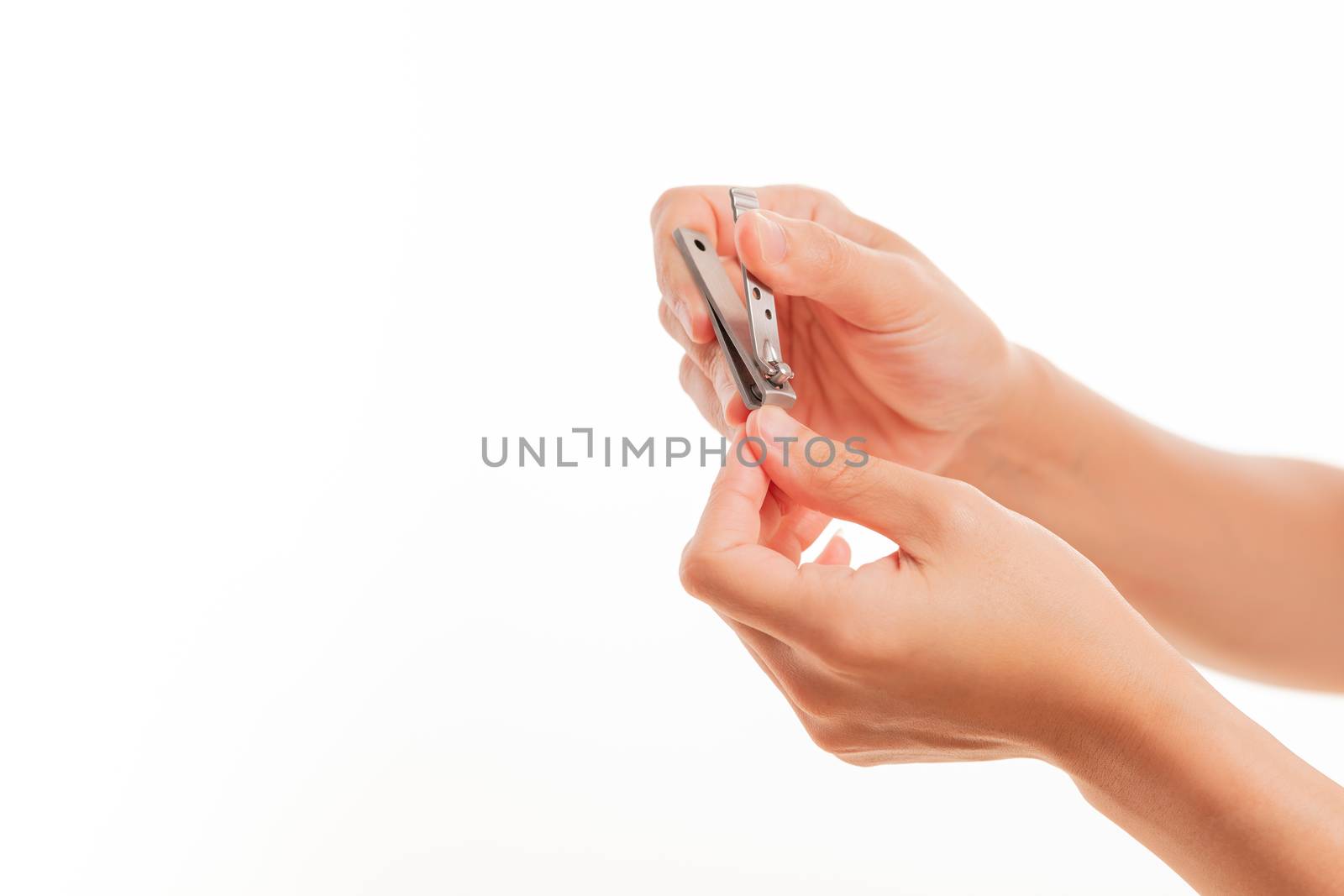 woman hand cutting nails using nail clipper on white backgrounds