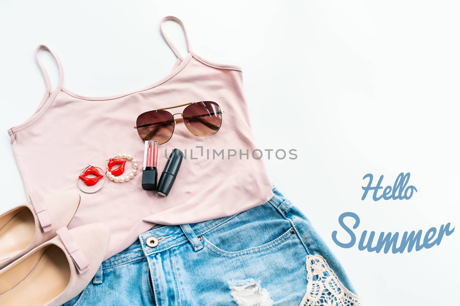 Hello summer concept. Female clothes, and accessories layout on white background. Flat lay. Top View