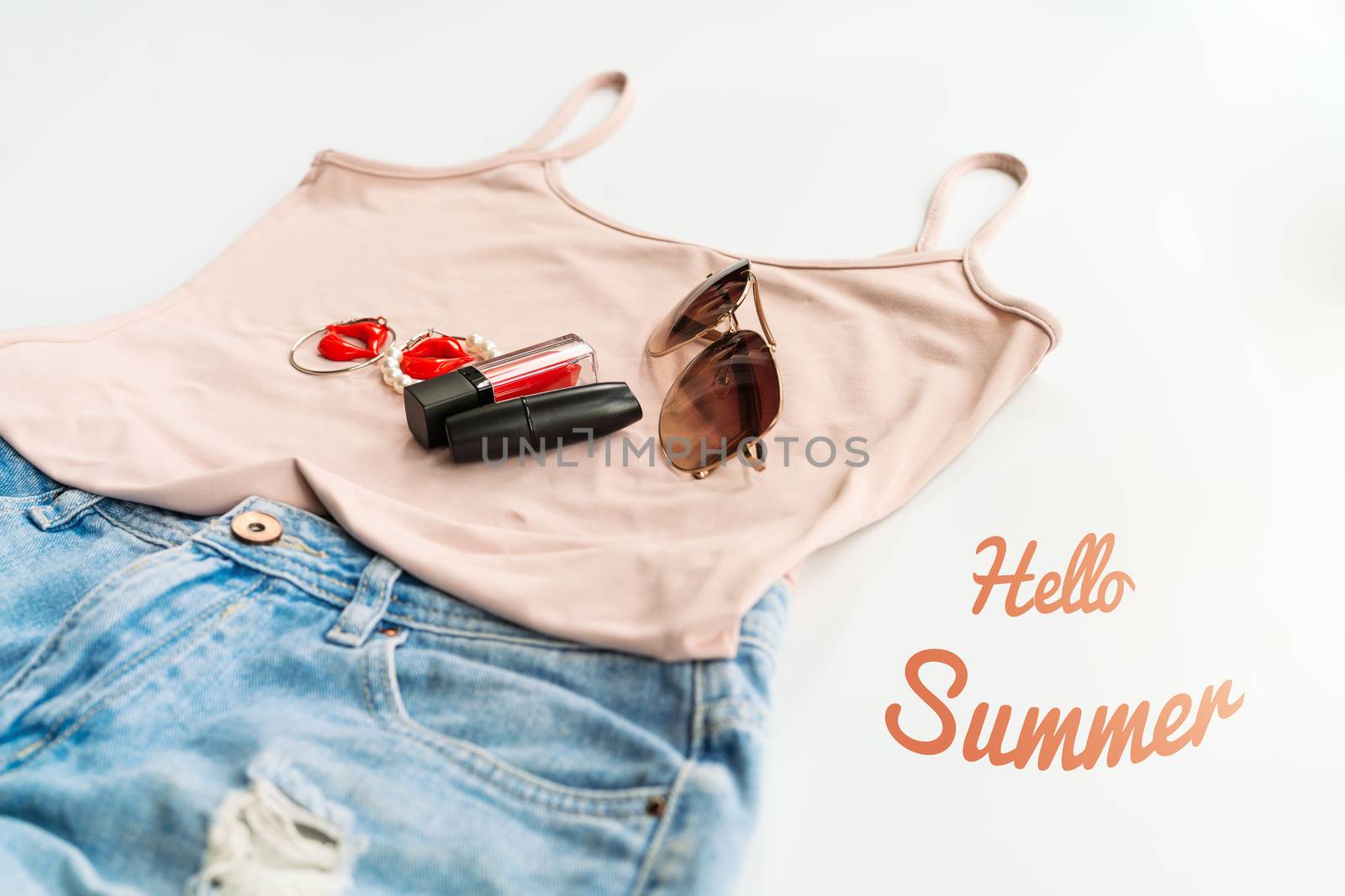 Hello summer concept. Female clothes, and accessories layout on white background. Flat lay. Top View