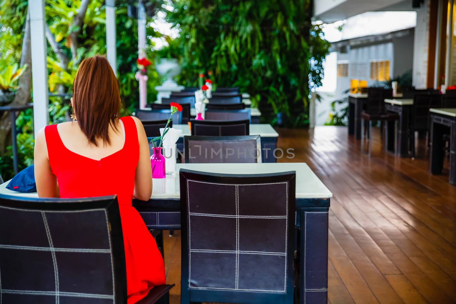 The restaurant atmosphere wooden table with white top and red carnation