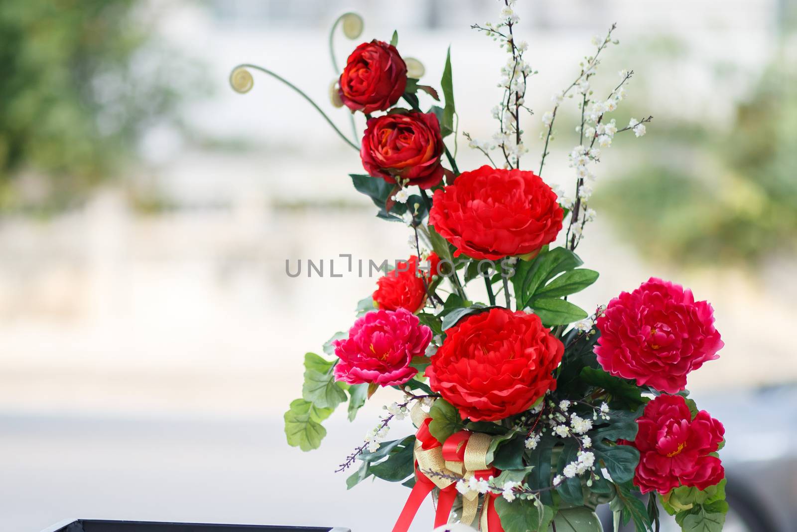 Batch of red carnation flower in glass jar