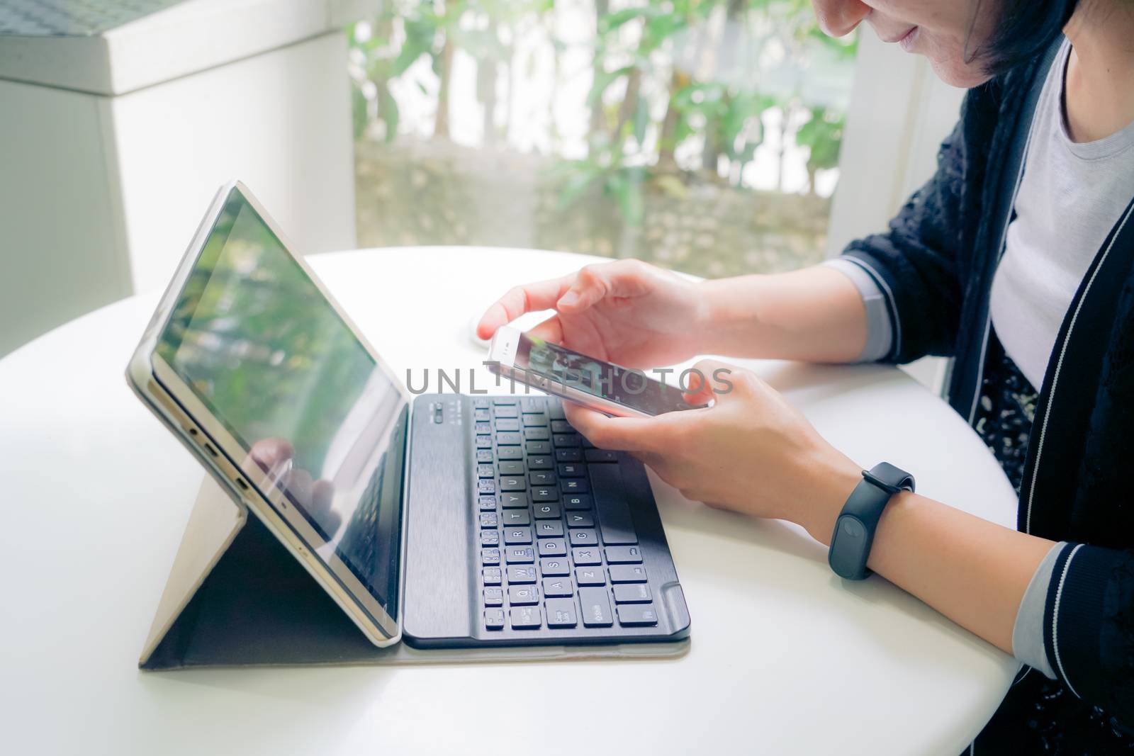 Young student women wearing smart band focus on her tablet compu by psodaz