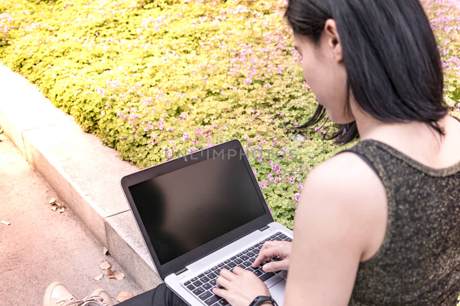 A laptop computer is using for surfing internet by student women