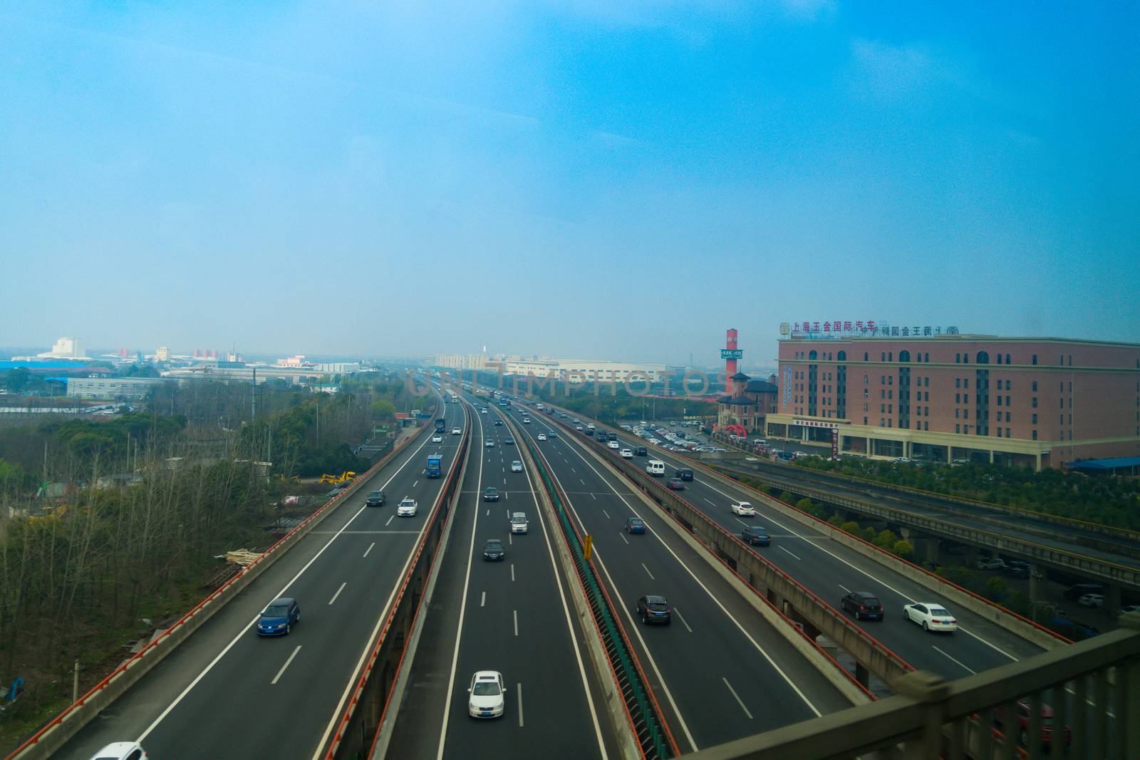 SHANGHAI, CHINA APRIL 2017 : the highway of suburb Shanghai in cloudy day, taking from the high-speed train.