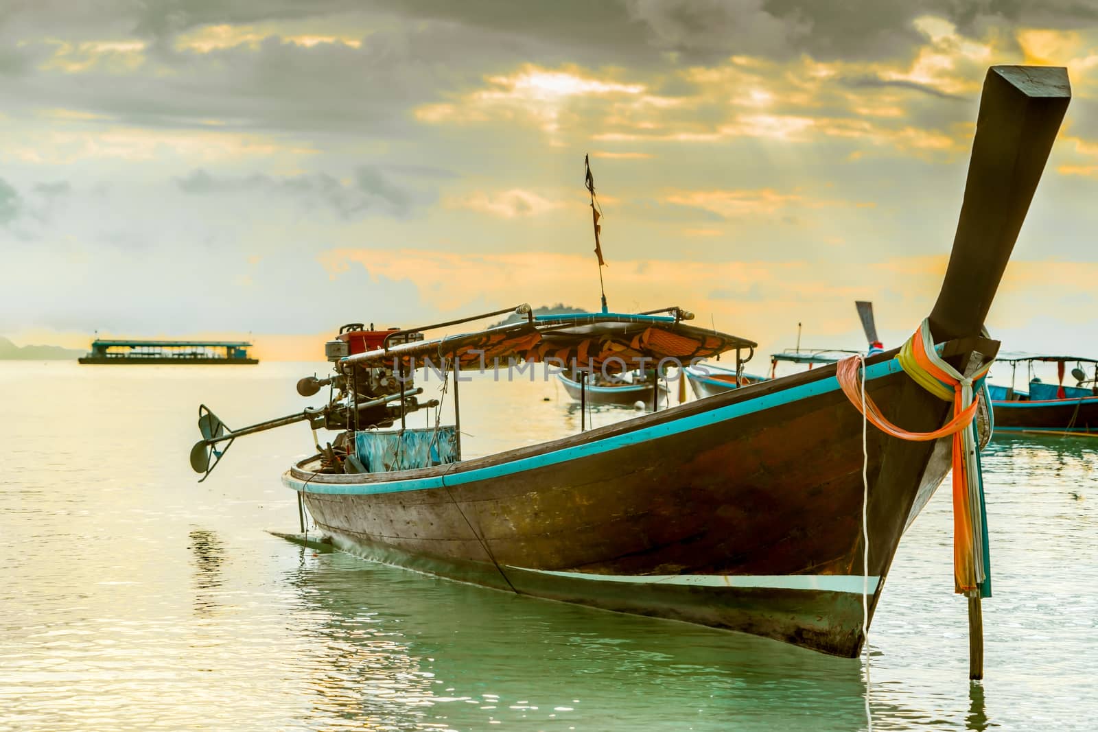 long tailed boat, fishing boat, motor boat with the sunrays