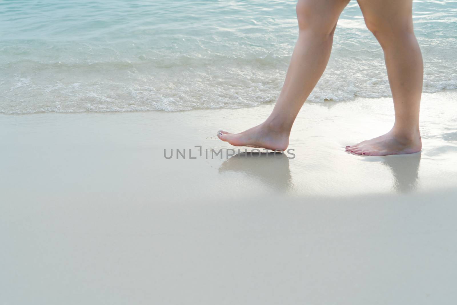 Beach travel - blur girl's walking on the white sand beach, vacation and relax - soft skin filter