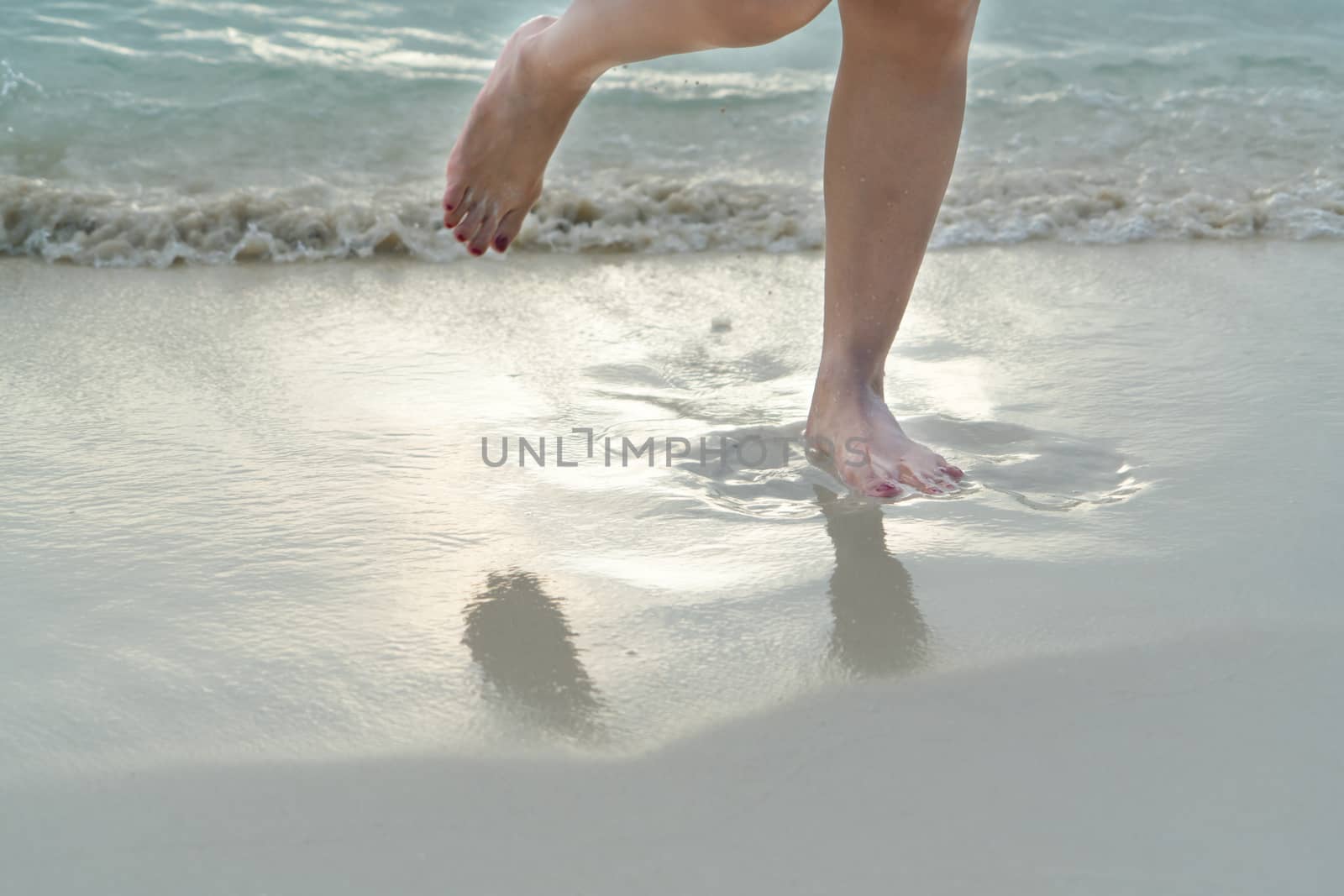 Beach travel - girl walking on the white sand beach, vacation and relax