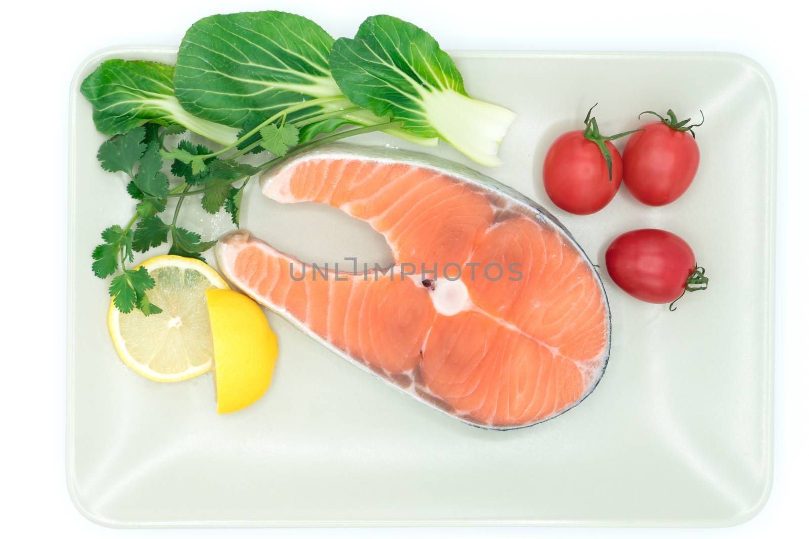 raw salmon steak with vegetable on plate, food and vegetable concept
