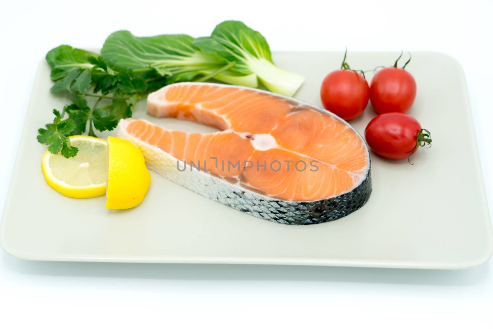 raw salmon steak with vegetable on plate, food and vegetable concept