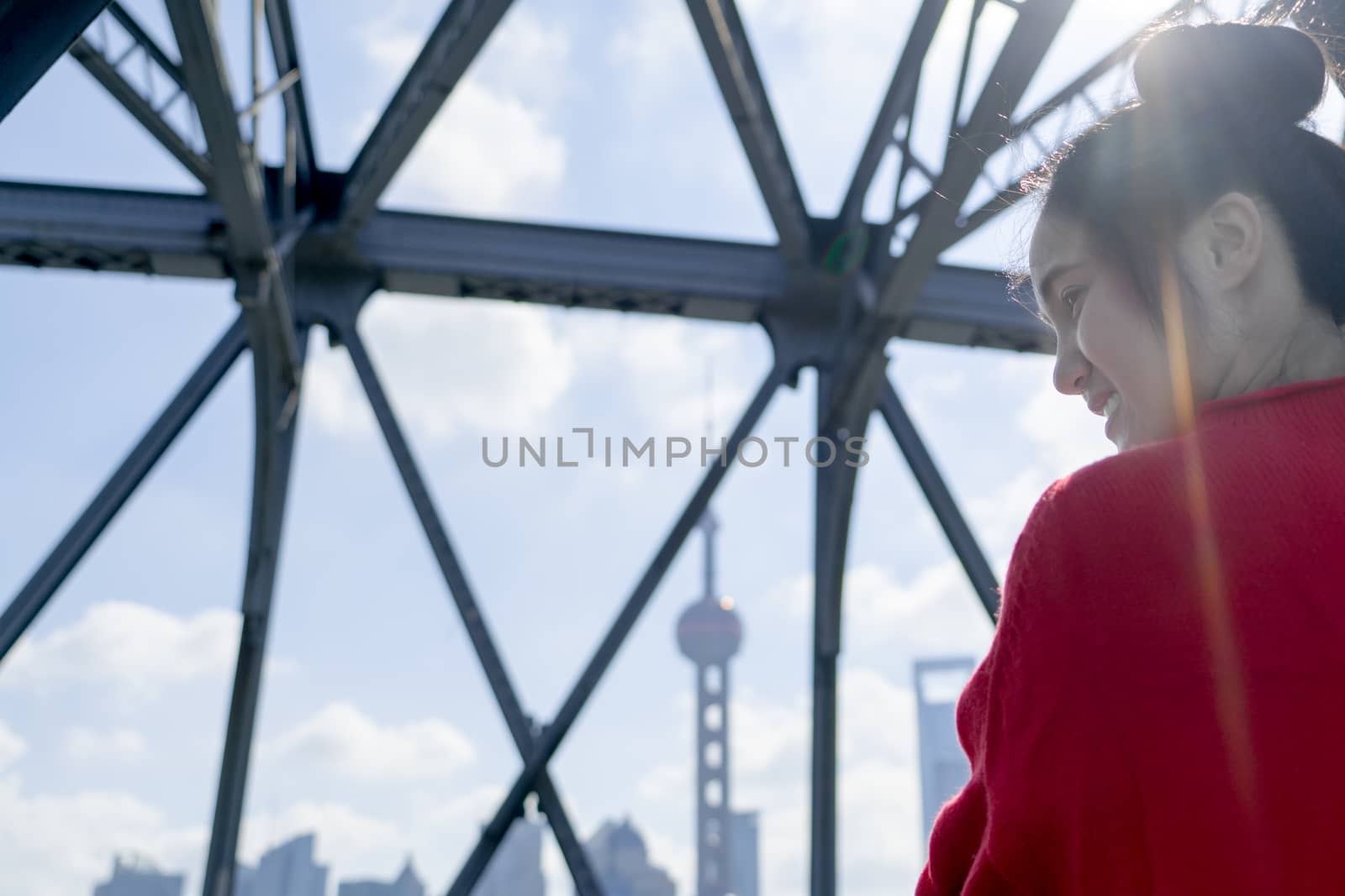 the blur background of pearl tower with the girl in red sweater