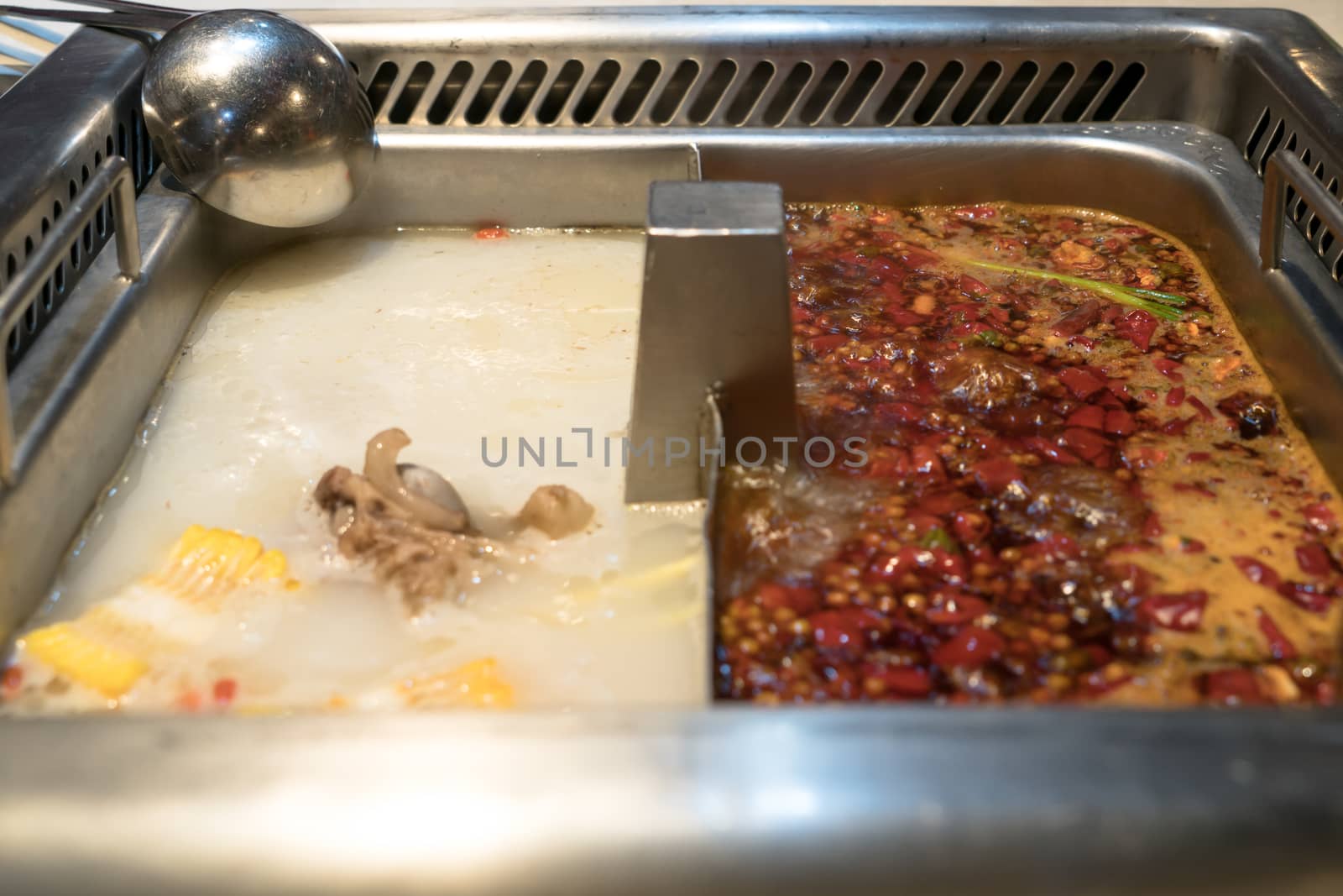 Boiling shabu pot in Chinese style - pork soup and oily spicy soup