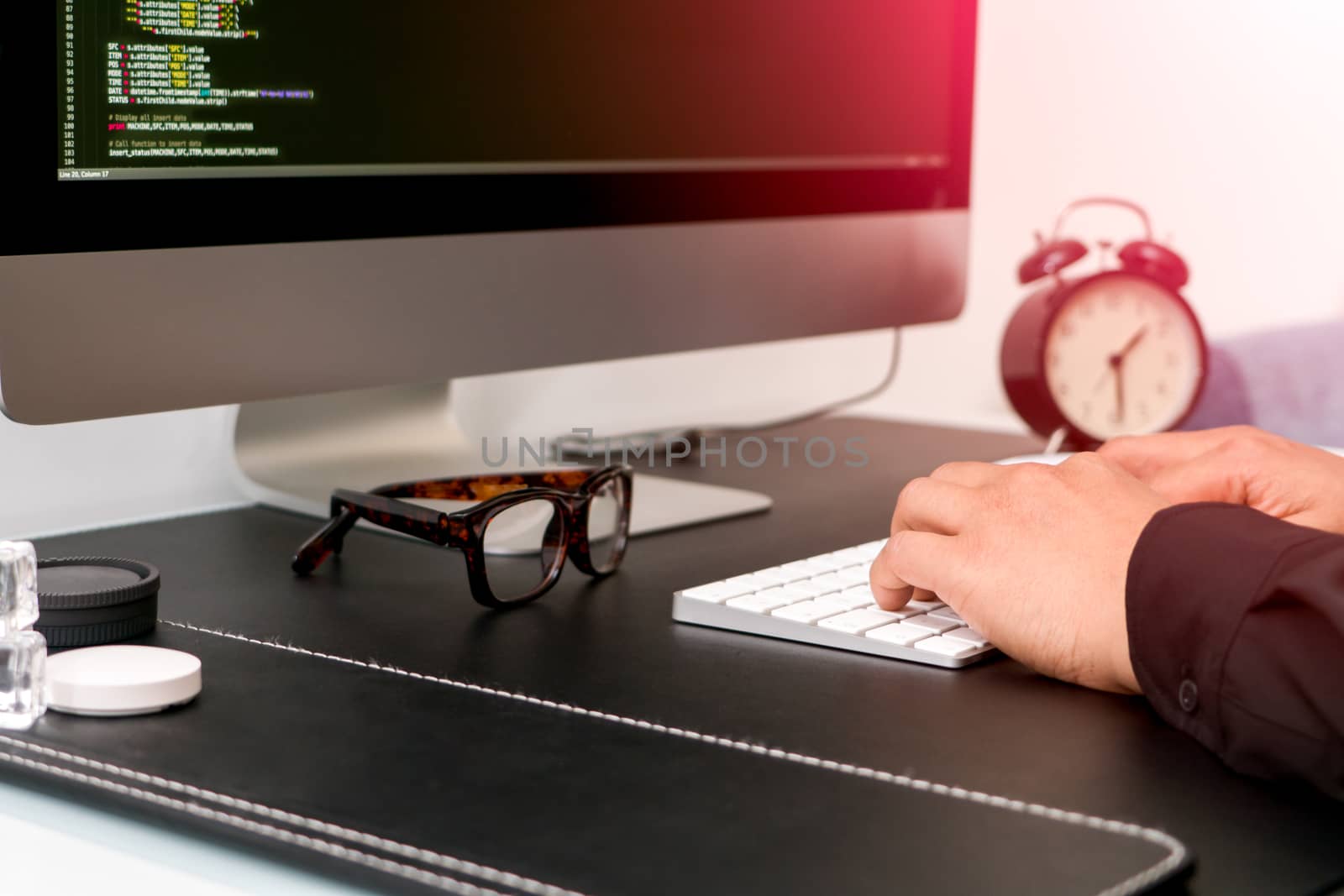 closeup of programmer hand on white keyboard while working by psodaz