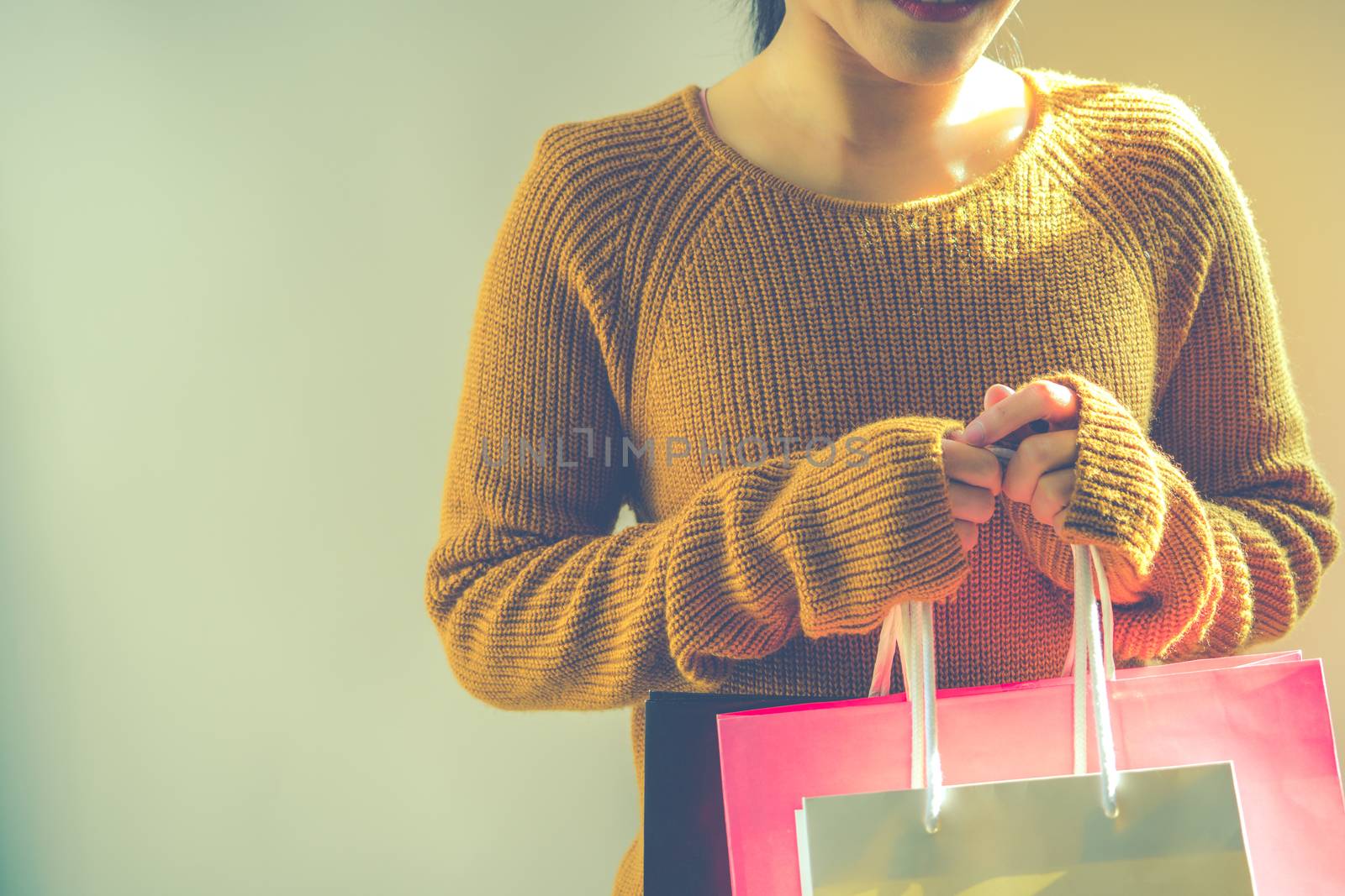 Happy girl holding the colorful shopping bag for family new year by psodaz