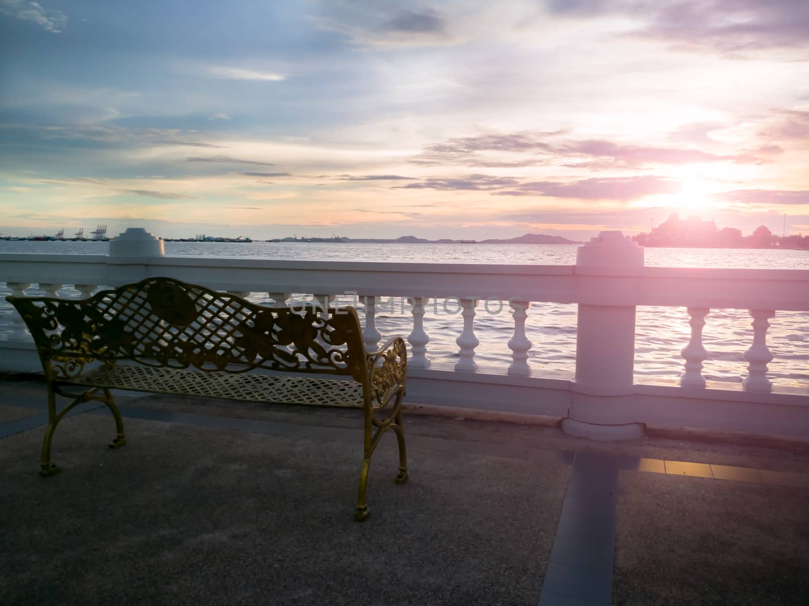the lonely chair and sunset at the riverside, sunlight landscape background