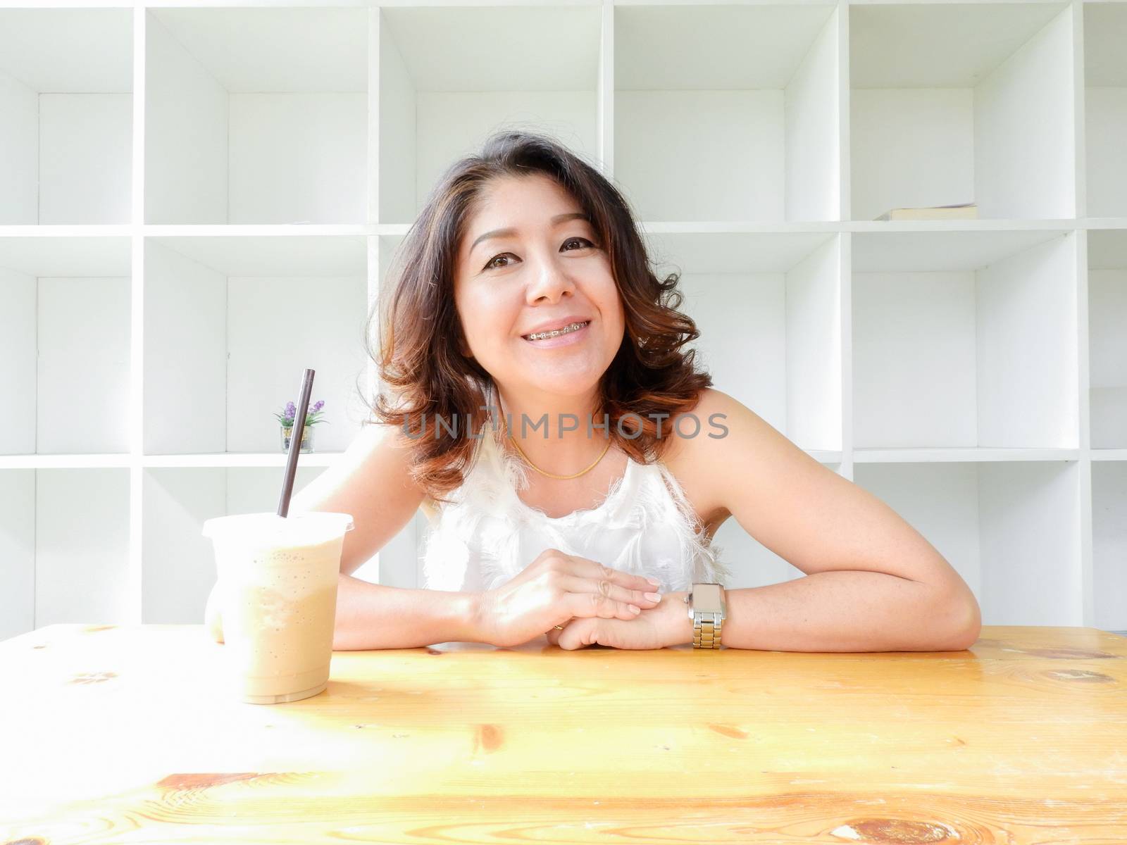 Beautiful woman smiling happy against white background.
