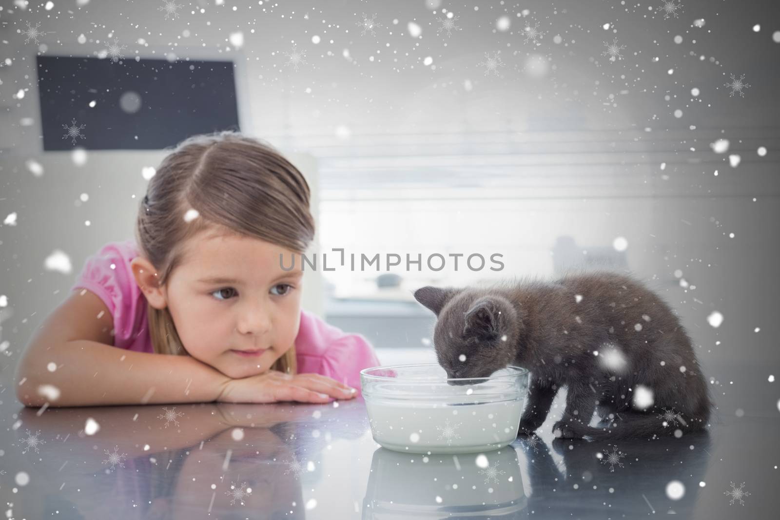 Composite image of girl looking at kitten drinking milk from bowl against snow falling