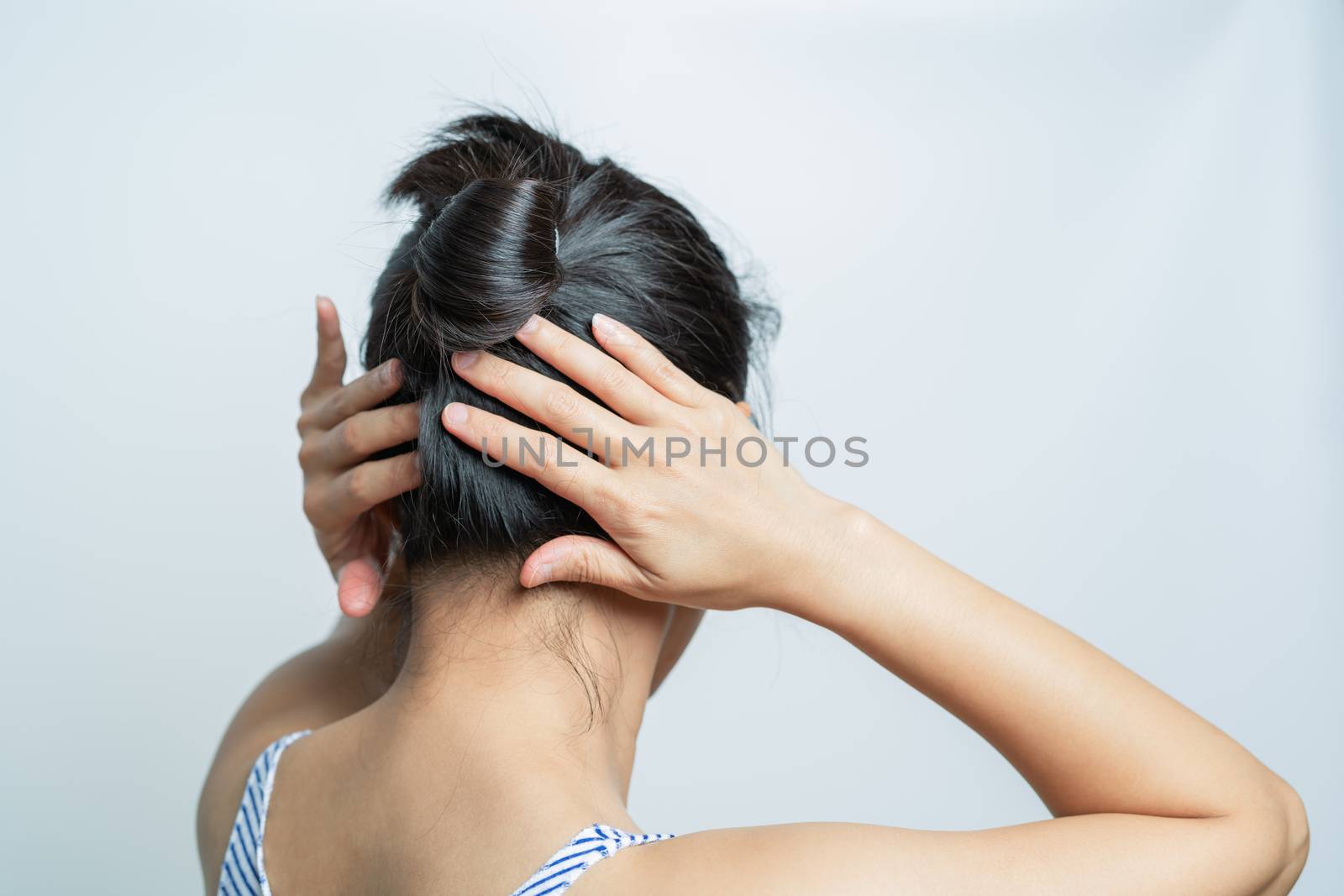 rear view of women tightening the hair, lifestyle concept