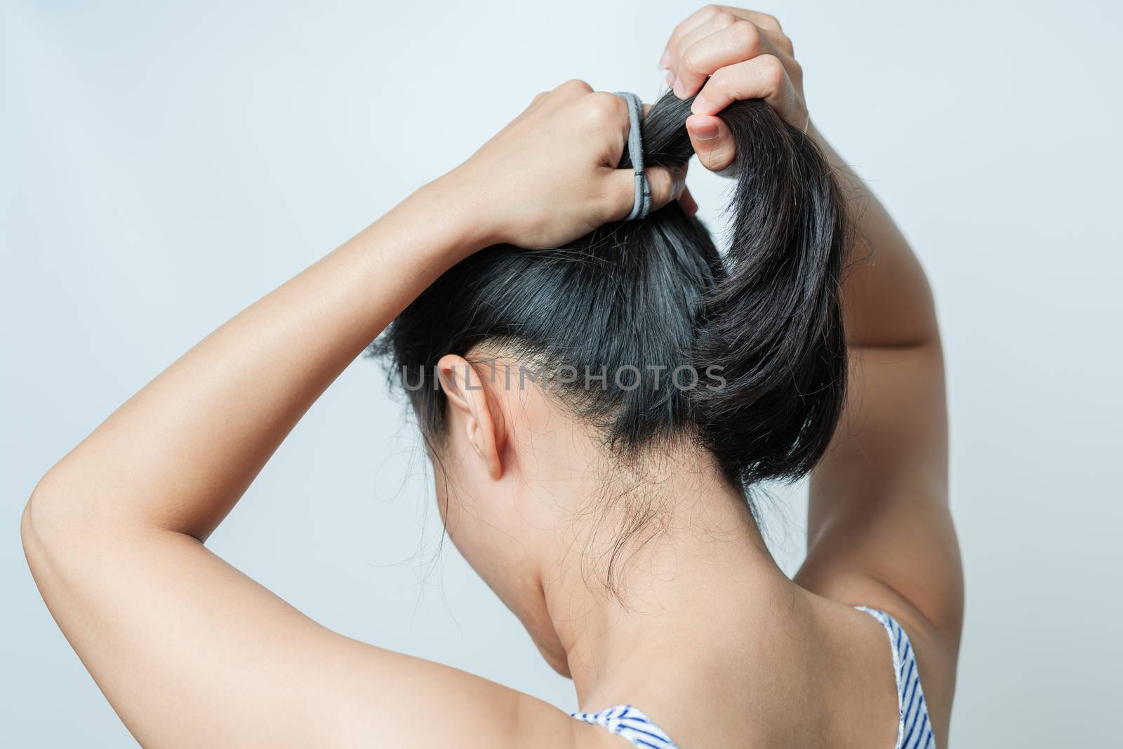 rear view of women tightening the hair, lifestyle concept